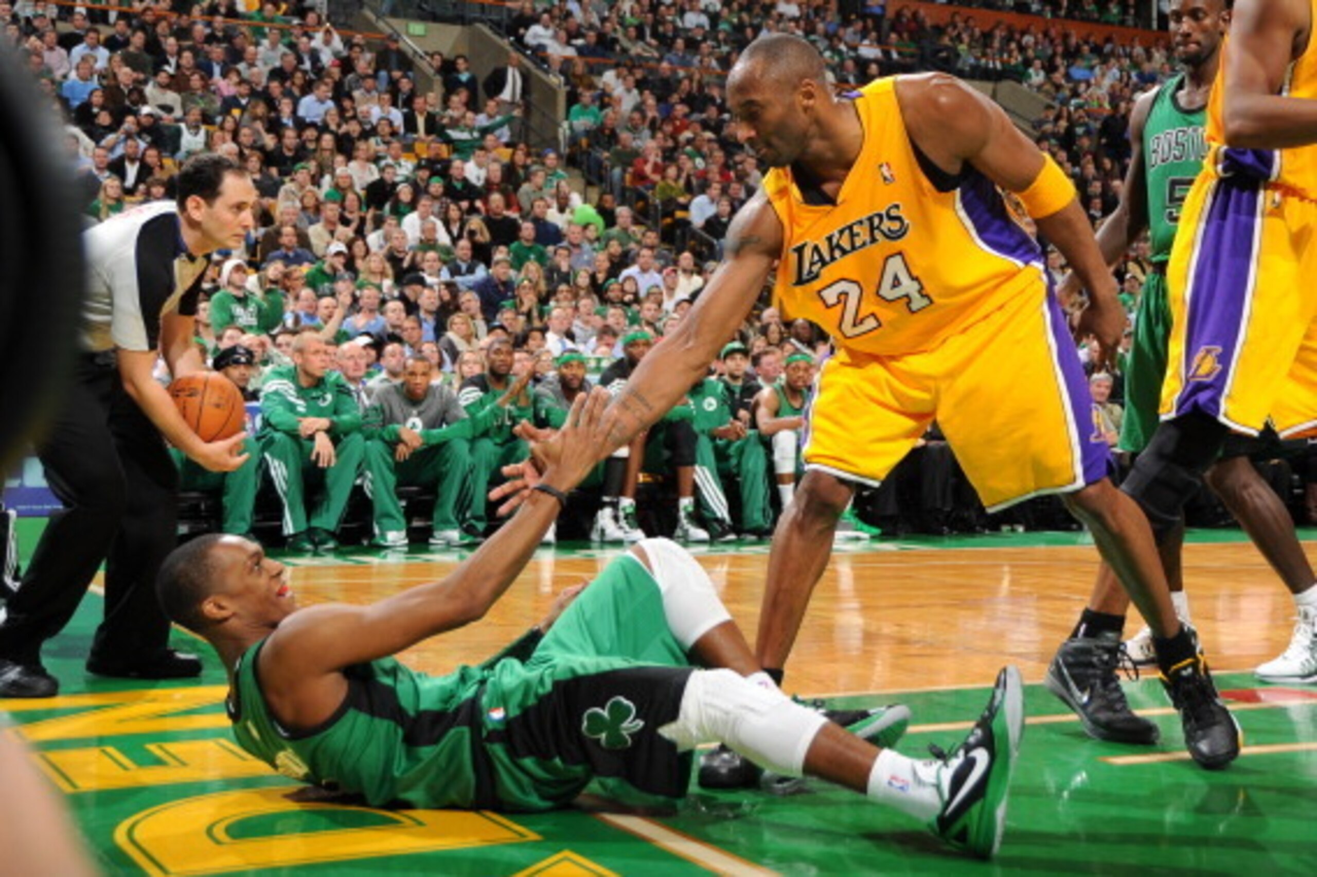 BOSTON, MA - FEBRUARY 9: Kobe Bryant #24 of the Los Angeles Lakers helps up Rajon Rondo #9 of the Boston Celtics on February 9, 2012 at the TD Garden in Boston, Massachusetts. NOTE TO USER: User expressly acknowledges and agrees that, by downloading and o