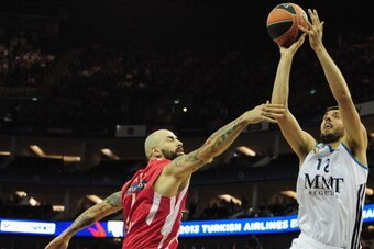 LONDON, ENGLAND - MAY 12:  Nikola Mirotic of Real Madrid tussles with Antic Pero of Olympiacos Piraeus during the Turkish Airlines EuroLeague Final Four final between Olympiacos Piraeus and Real Madrid at the O2 Arena on May 12, 2013 in London, England.  