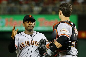 WASHINGTON, DC - OCTOBER 03:  Buster Posey #28 and Santiago Casilla #46 of the San Francisco Giants celebrate their 3 to 2 win over the Washington Nationals during Game One of the National League Division Series at Nationals Park on October 3, 2014 in Was
