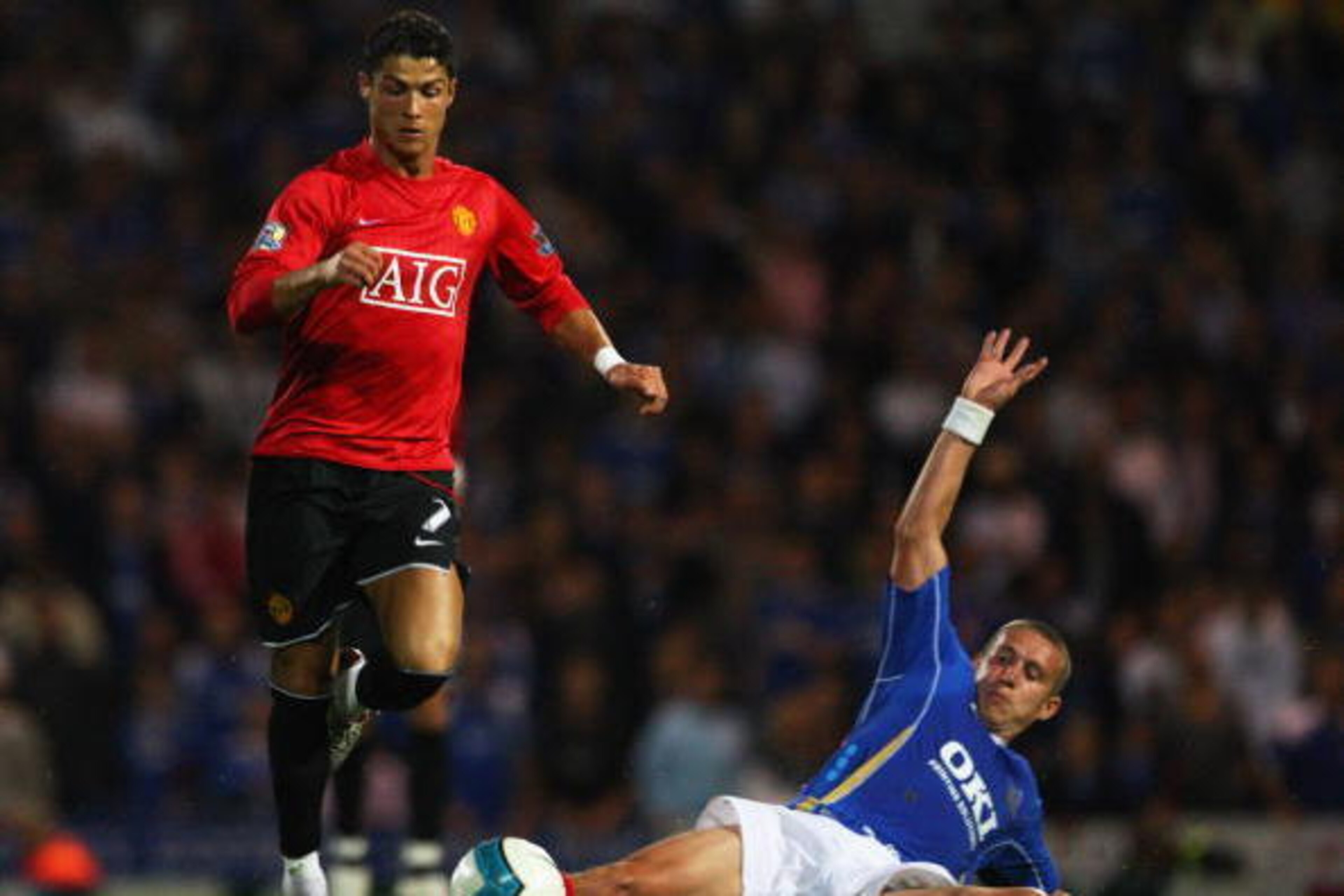 PORTSMOUTH, UNITED KINGDOM - AUGUST 15:  Cristiano Ronaldo of Manchester United hurdles the challenge from Sean Davis of Portsmouth during the Barclays Premier League match between Portsmouth and Manchester United at Fratton Park on August 15, 2007 in Por
