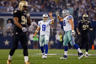 ARLINGTON, TX - SEPTEMBER 28:  Tony Romo #9 of the Dallas Cowboys celebrates with Doug Free #68 of the Dallas Cowboys as the Cowboys take on the New Orleans Saints in the second half at AT&T Stadium on September 28, 2014 in Arlington, Texas.  (Photo by To