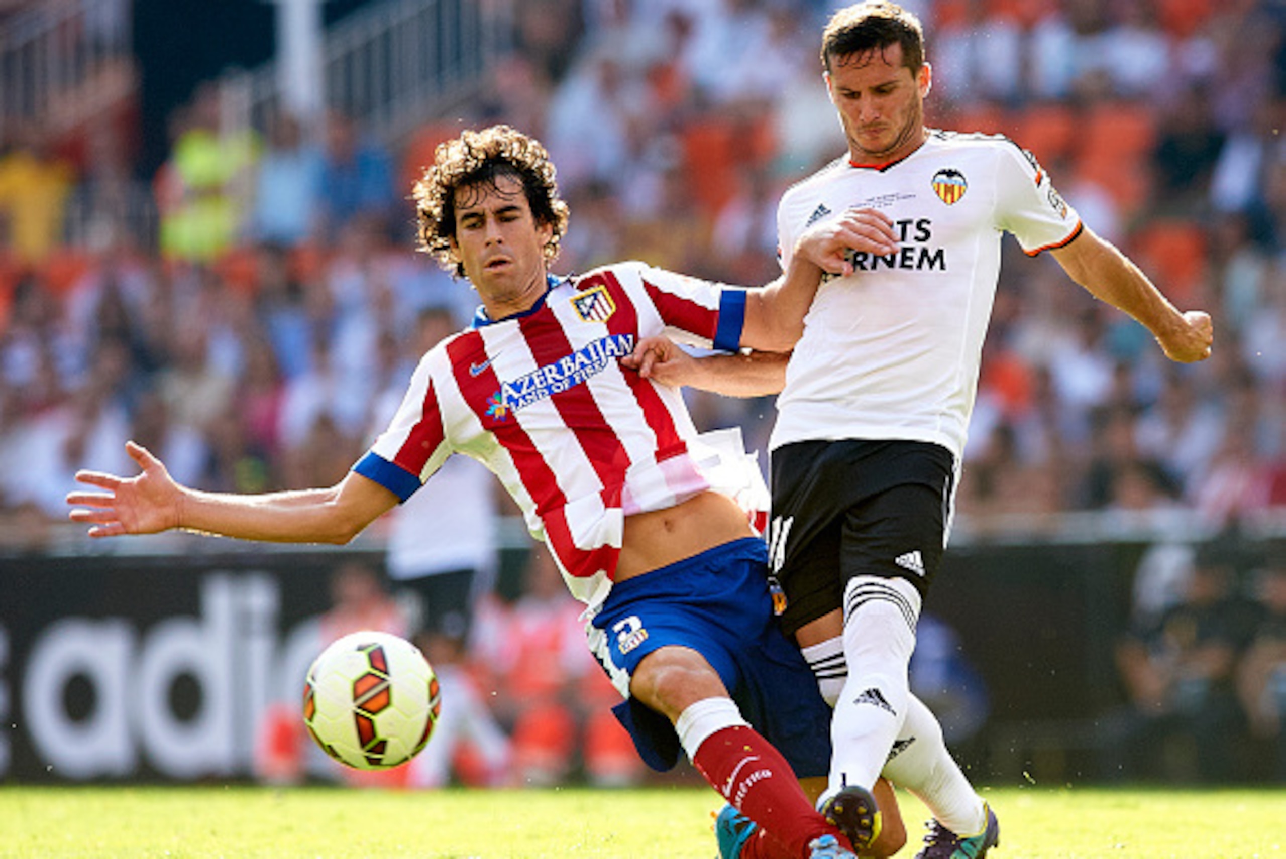 VALENCIA, SPAIN - OCTOBER 04:  Pablo Piatti (R) of Valencia is tackled by Tiago Cardoso of Atletico de Madrid during the La Liga match between Valencia CF and Club Atletico de Madrid at Estadi de Mestalla on October 4, 2014 in Valencia, Spain.  (Photo by 