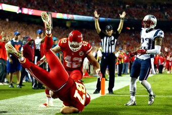 KANSAS CITY, MO - SEPTEMBER 29:  Travis Kelce #87 of the Kansas City Chiefs scores a touchdown as  Patrick Chung #23 of the New England Patriots defends at Arrowhead Stadium on September 29, 2014 in Kansas City, Missouri.  (Photo by Dilip Vishwanat/Getty 