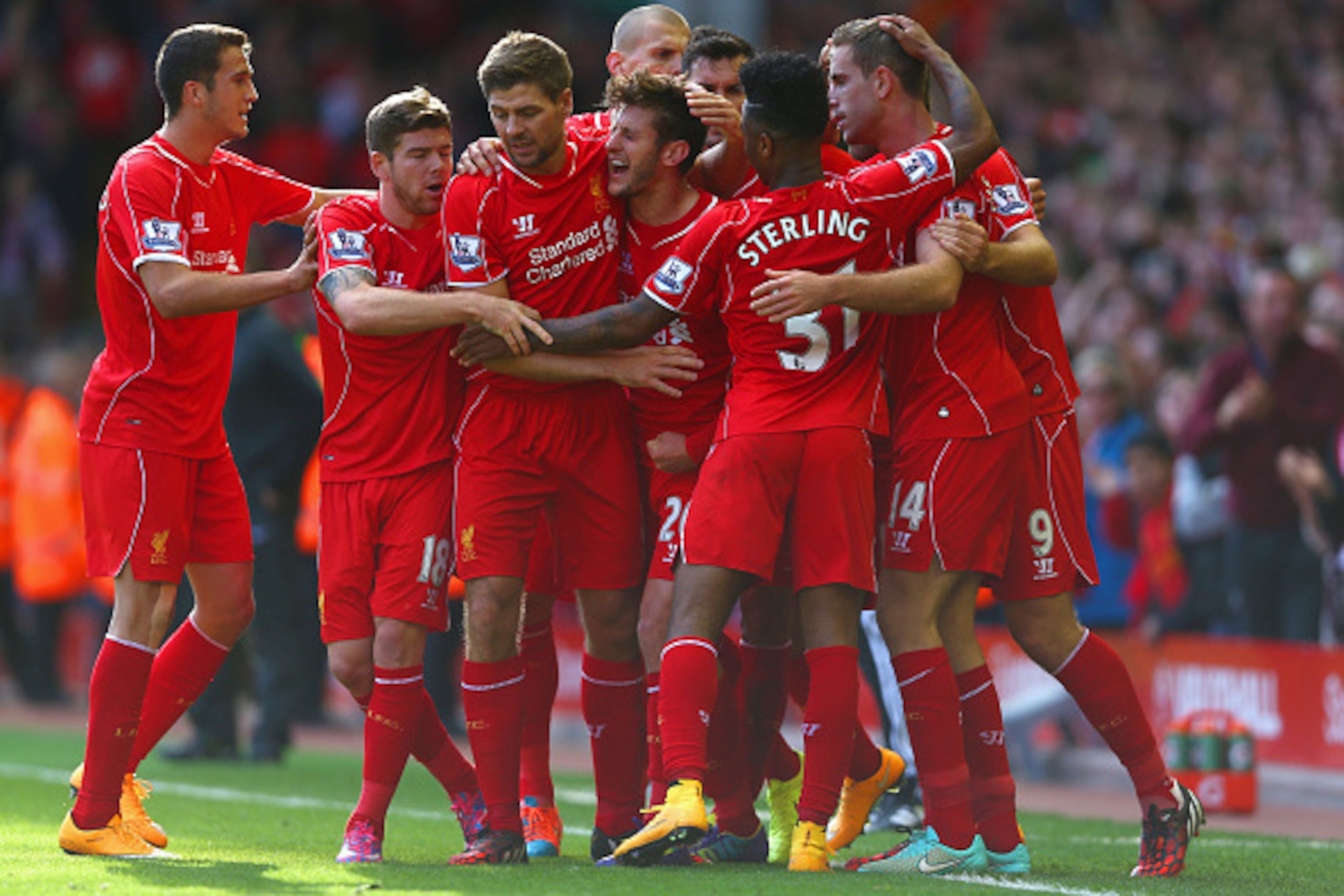 LIVERPOOL, ENGLAND - OCTOBER 04:  Adam Lallana of Liverpool is congratulated by team mates on scoring the opening goal during the Barclays Premier League match between Liverpool and West Bromwich Albion at Anfield on October 4, 2014 in Liverpool, England.