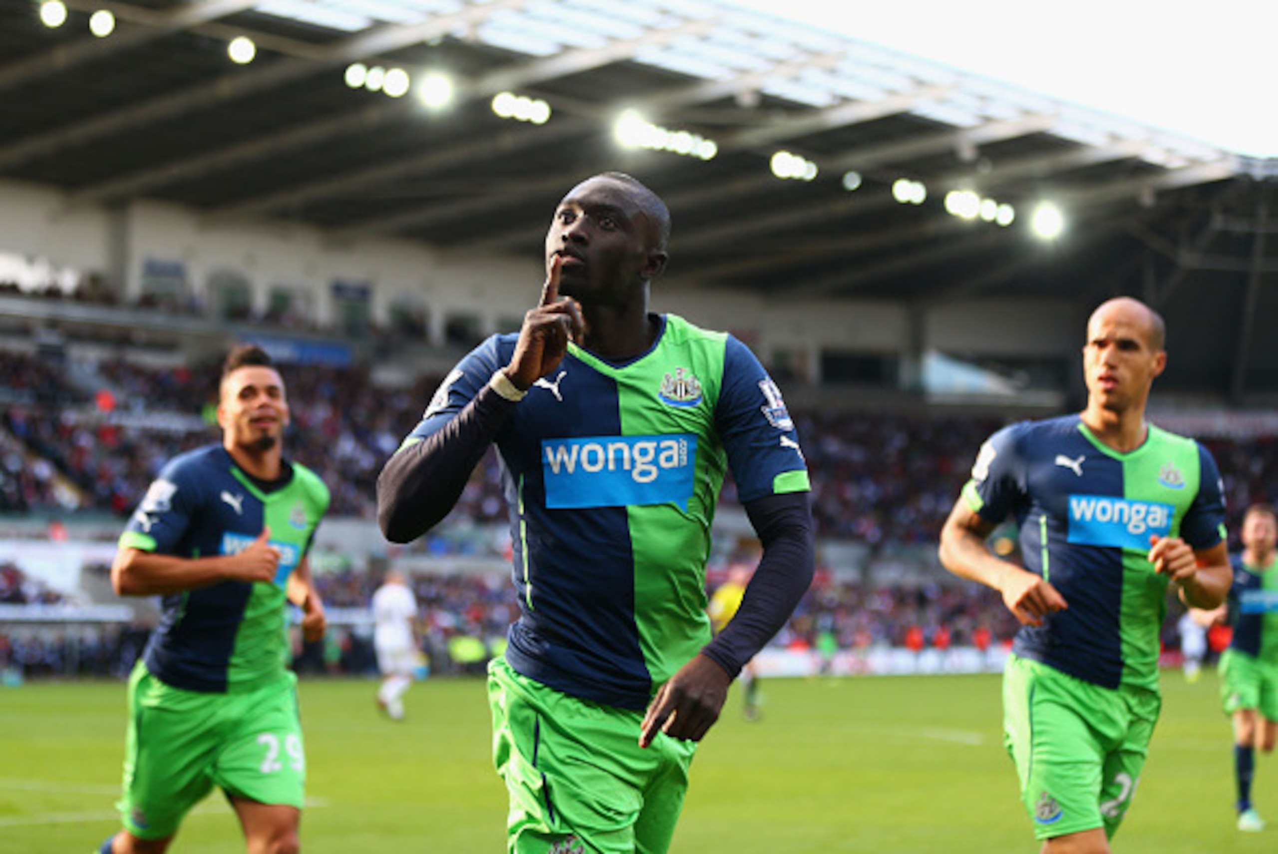 SWANSEA, WALES - OCTOBER 04:  Papiss Demba Cisse of Newcastle United (C) celebrates as he scores their second goal during the Barclays Premier League match between Swansea City and Newcastle United at Liberty Stadium on October 4, 2014 in Swansea, Wales. 