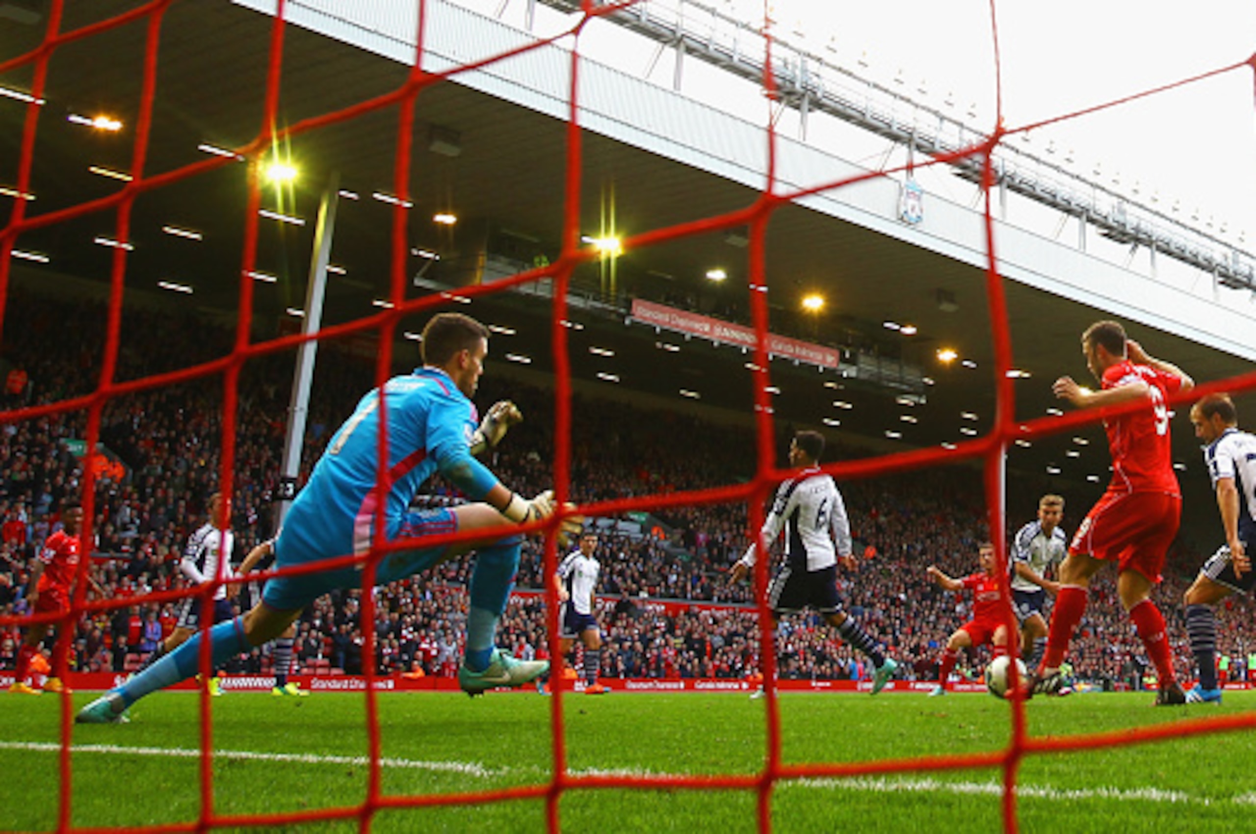 LIVERPOOL, ENGLAND - OCTOBER 04:  Jordan Henderson of Liverpool scores their second goal past Ben Foster of West Brom during the Barclays Premier League match between Liverpool and West Bromwich Albion at Anfield on October 4, 2014 in Liverpool, England. 