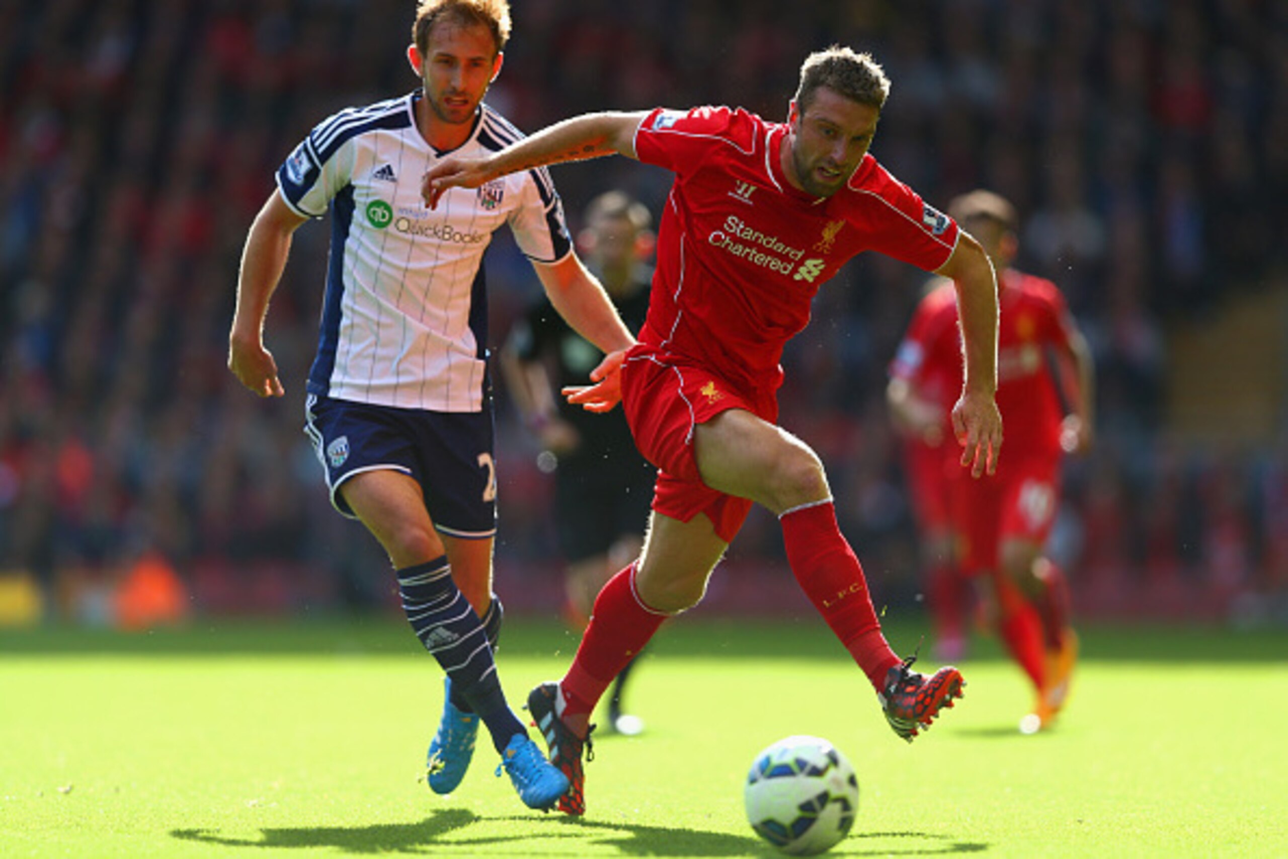 LIVERPOOL, ENGLAND - OCTOBER 04:  Rickie Lambert of Liverpool and Craig Dawson of West Brom battle for the ball during the Barclays Premier League match between Liverpool and West Bromwich Albion at Anfield on October 4, 2014 in Liverpool, England.  (Phot