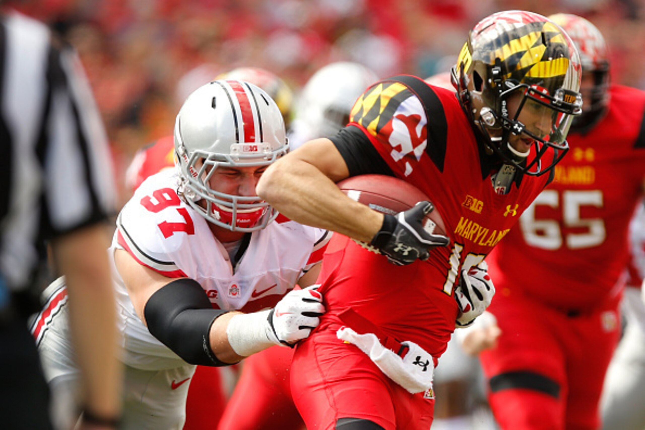 COLLEGE PARK, MD - OCTOBER 04:  Defensive end Joey Bosa #97 of Ohio State (L) sacks Quarterback C.J. Brown #16 of Maryland during the first half of their game at Byrd Stadium on October 4, 2014 in College Park, Maryland.  (Photo by Jonathan Ernst/Getty Im