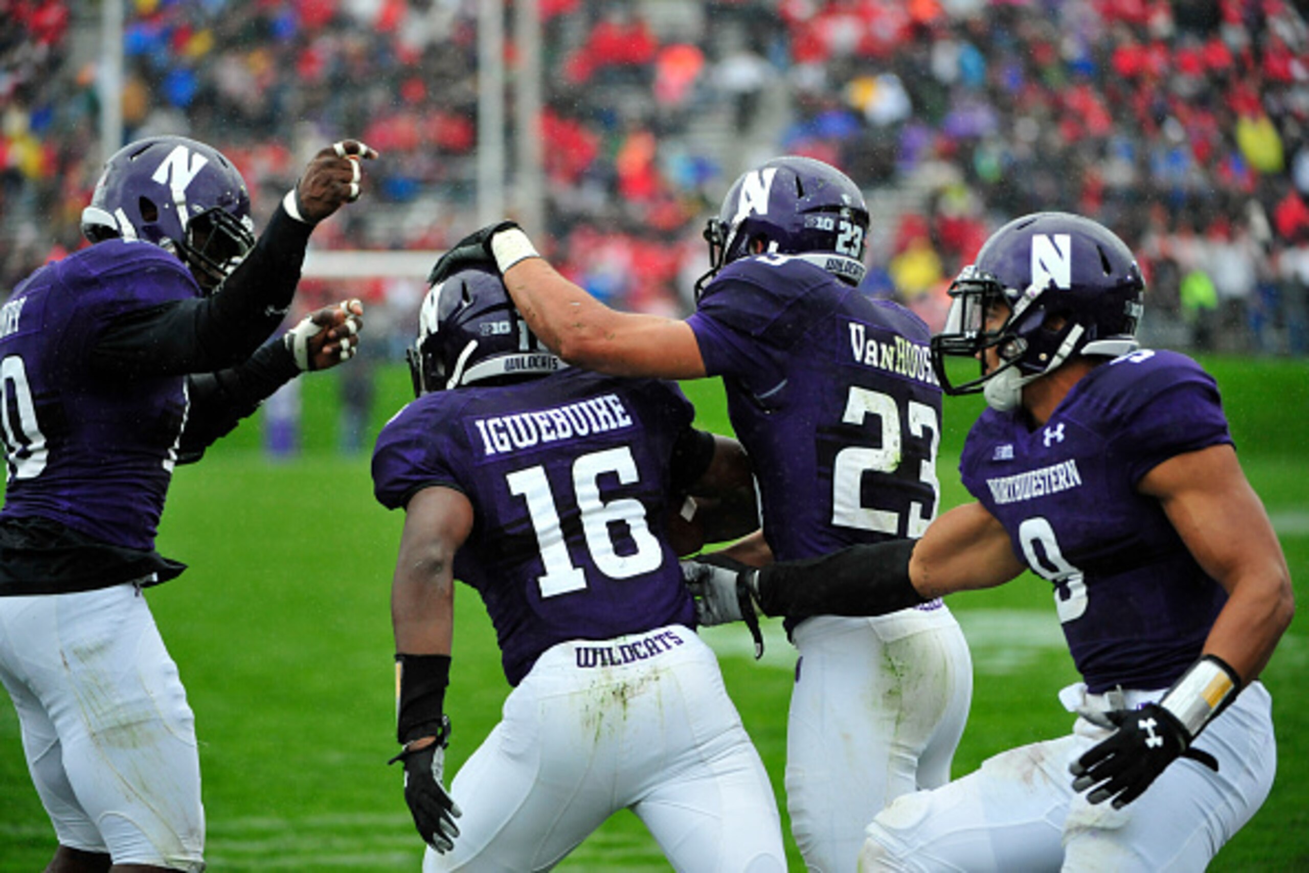 EVANSTON, IL- OCTOBER 04:  Godwin Igwebuike #16 of the Northwestern Wildcats  is greeted after intercepting a pass against the Wisconsin Badgers during the first half on October 4, 2014 at Ryan Field in Evanston, Illinois.  (Photo by David Banks/Getty Ima
