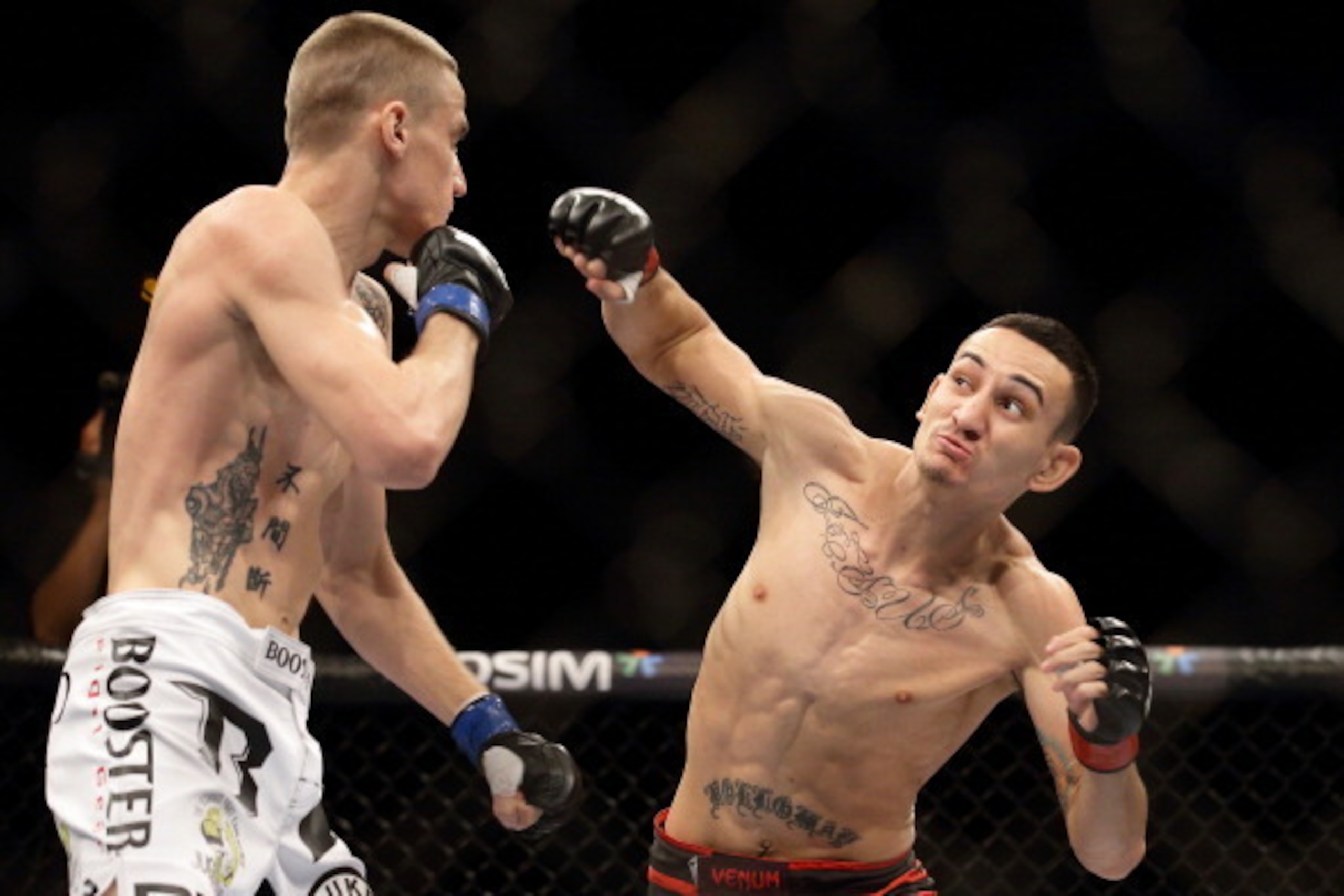 SINGAPORE - JANUARY 04:  Will Chope (L) fights Max Holloway  during their UFC Fight Night Singapore featherweight bout at Marina Bay Sands on January 4, 2014 in Singapore.  (Photo by Suhaimi Abdullah/Getty Images)
