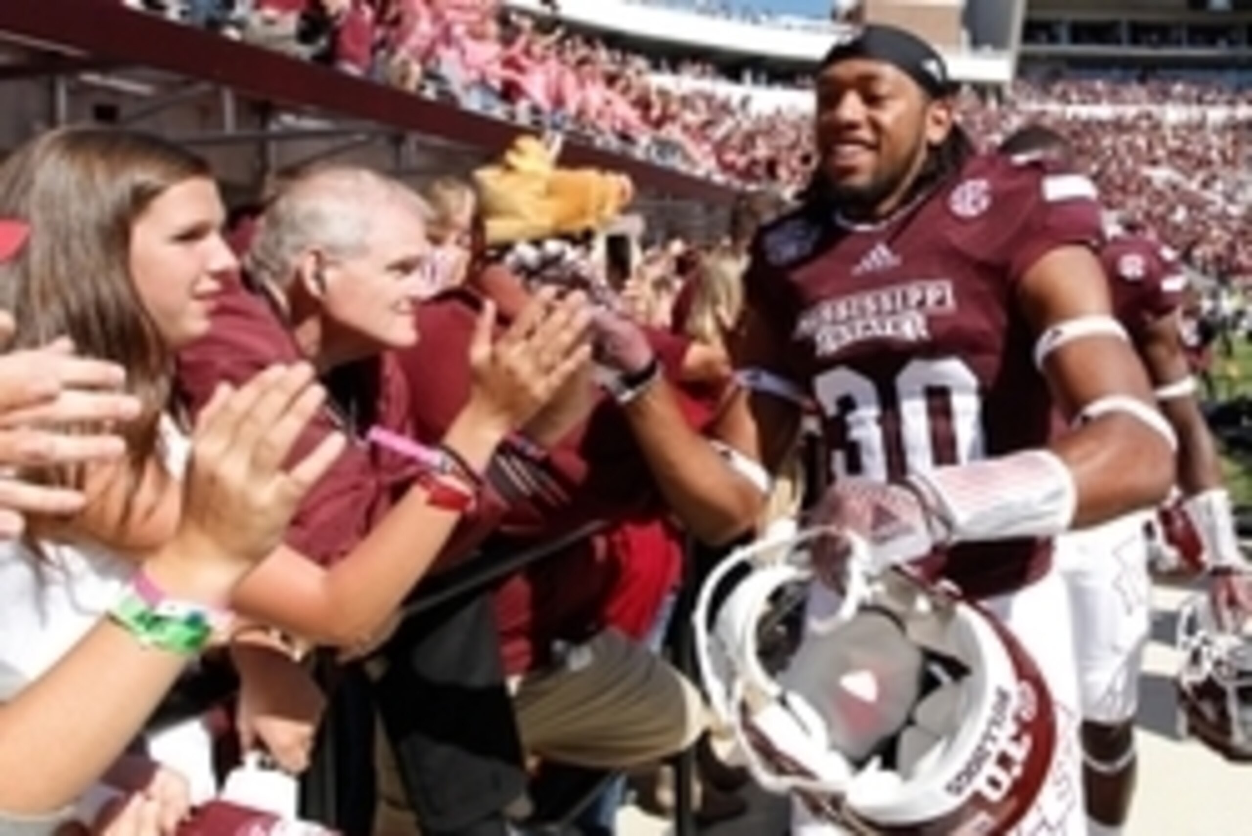 Oct 4, 2014; Starkville, MS, USA; Mississippi State Bulldogs Brandon Wells (30) celebrates with the fans his teams win against the Texas A&M Aggies at Davis Wade Stadium. The Bulldogs defeated the Aggies 48-31. Mandatory Credit: Marvin Gentry-USA TODAY Sp