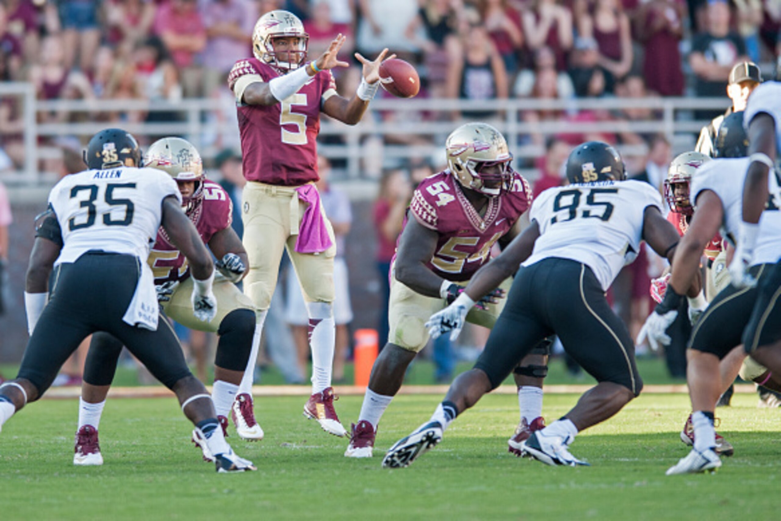 TALLAHASSEE, FL - OCTOBER 4: Quarterback Jameis Winston #5 of the Florida State Seminoles catches a high hike during the second half at Doak Campbell Stadium on October 4, 2014 in Tallahassee, Florida. The Seminoles took the Deamon Deacons 43-3. (Photo by