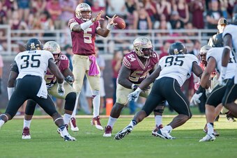 TALLAHASSEE, FL - OCTOBER 4: Quarterback Jameis Winston #5 of the Florida State Seminoles catches a high hike during the second half at Doak Campbell Stadium on October 4, 2014 in Tallahassee, Florida. The Seminoles took the Deamon Deacons 43-3. (Photo by