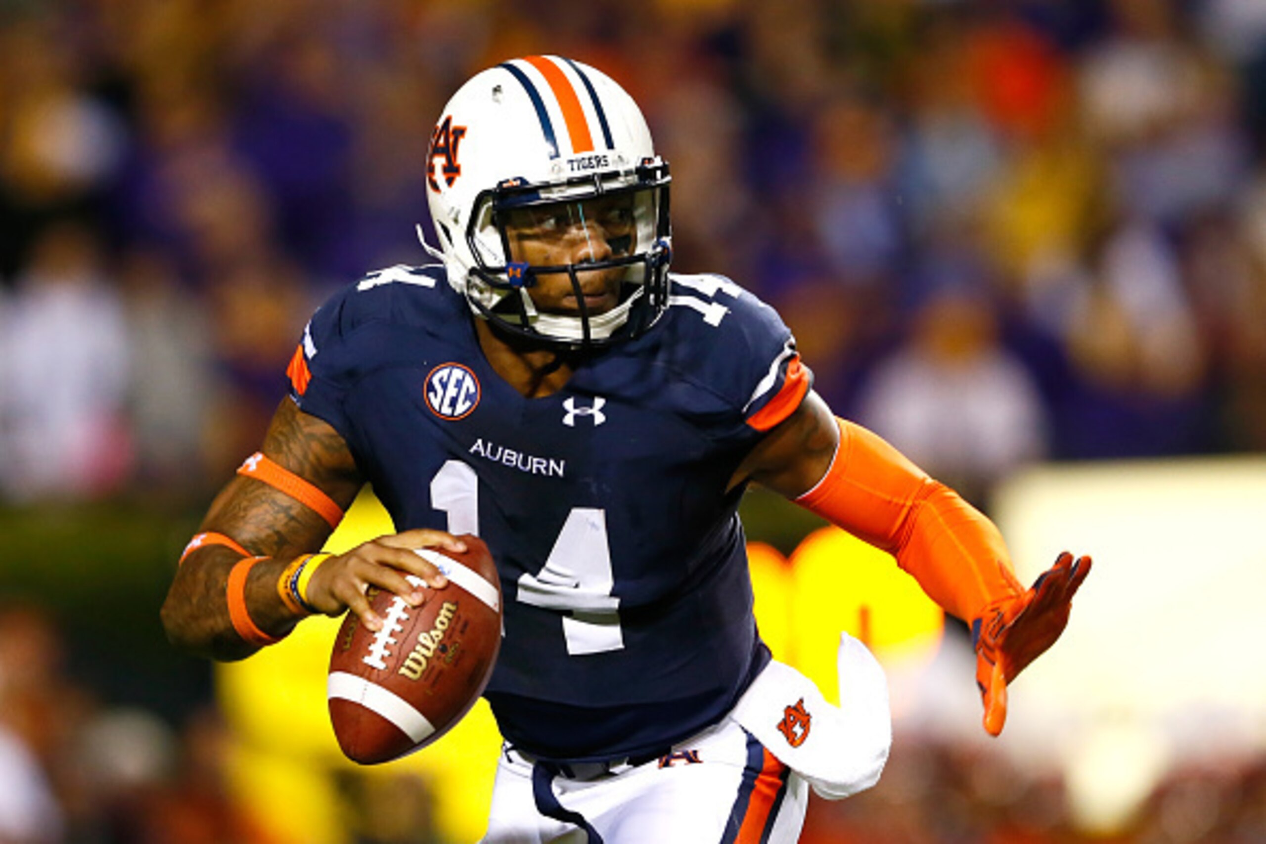 AUBURN, AL - OCTOBER 04:  Nick Marshall #14 of the Auburn Tigers is pressured out of the pocket against the LSU Tigers at Jordan Hare Stadium on October 4, 2014 in Auburn, Alabama.  (Photo by Kevin C. Cox/Getty Images)