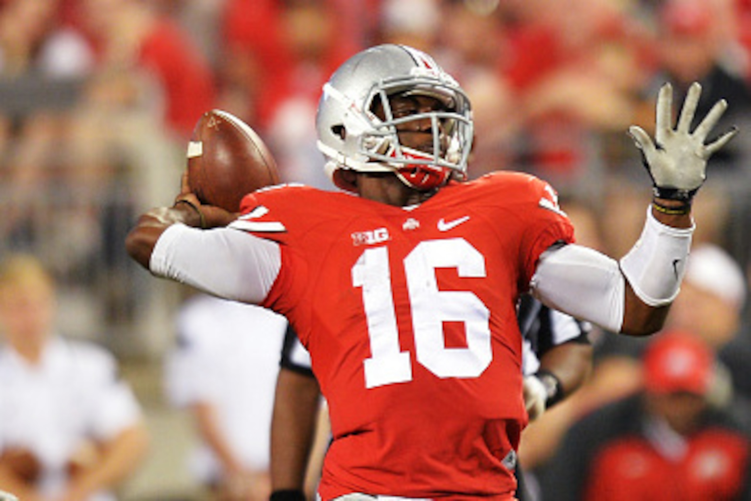 COLUMBUS, OH - SEPTEMBER 27:  Quarterback J.T. Barrett #16 of the Ohio State Buckeyes throws a 34-yard touchdown pass in the fourth quarter against the Cincinnati Bearcats at Ohio Stadium on September 27, 2014 in Columbus, Ohio. Ohio State defeated Cincin