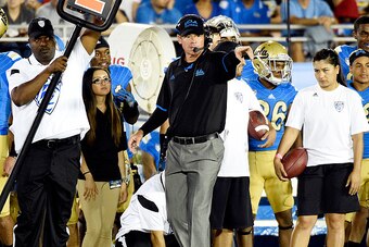 PASADENA, CA - OCTOBER 04: Jim Mora coach of the UCLA Bruins yells instructions form the sideline during the college football game against Utah Utes in the first half at the Rose Bowl October 04, 2014, in Pasadena, California. (Photo by Kevork Djansezian/