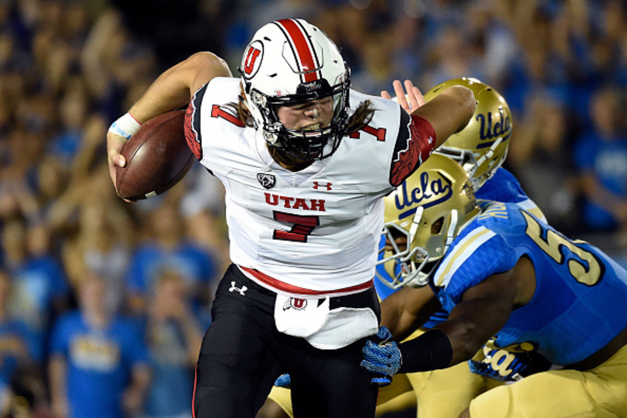 PASADENA, CA - OCTOBER 04: Quarterback Travis Wilson #7 of the Utah Utes scrambles out of the pocket as he is chased down by UCLA Bruins defenders during the first quarter at the Rose Bowl October 04, 2014, in Pasadena, California. (Photo by Kevork Djanse