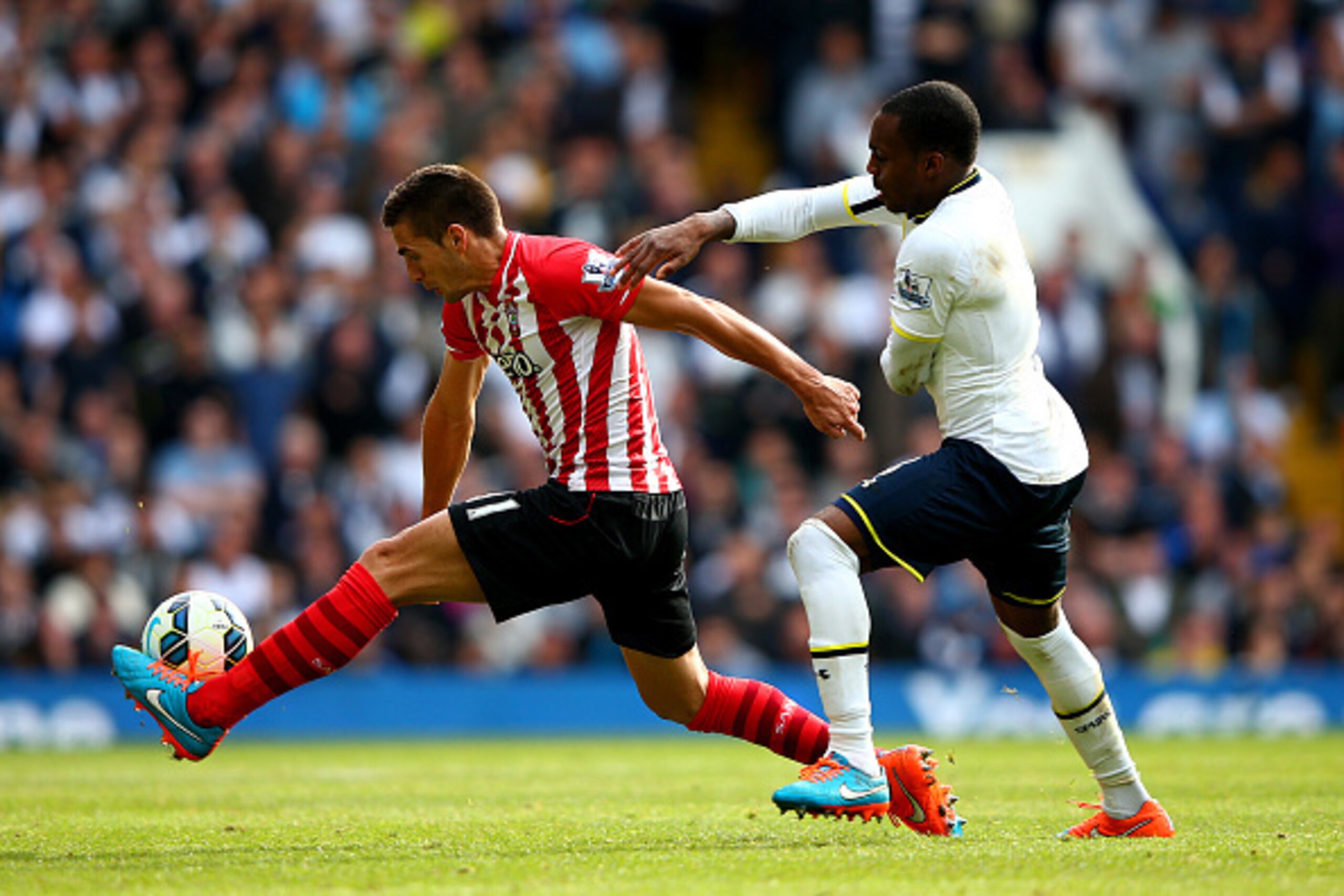 LONDON, ENGLAND - OCTOBER 05:  Dusan Tadic of Southampton battles for the ball with Danny Rose of Spurs during the Barclays Premier League match between Tottenham Hotspur and Southampton at White Hart Lane on October 5, 2014 in London, England.  (Photo by