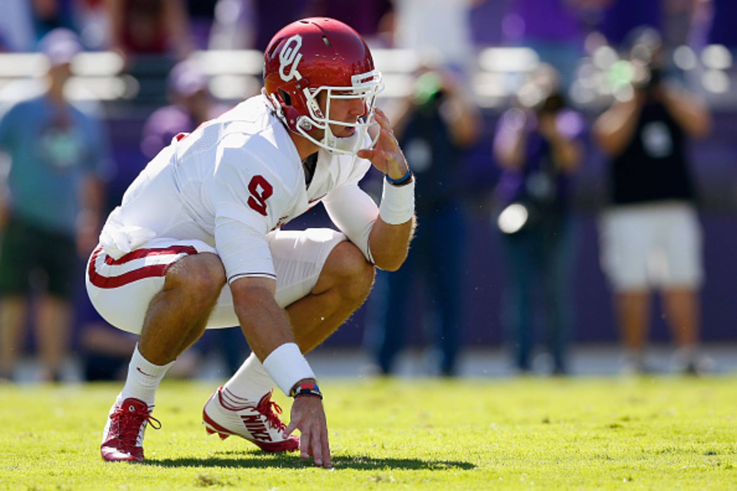 FORT WORTH, TX - OCTOBER 04:  Quarterback Trevor Knight #9 of the Oklahoma Sooners reacts after knocked down by the TCU Horned Frogs defense in the first half at Amon G. Carter Stadium on October 4, 2014 in Fort Worth, Texas.  (Photo by Tom Pennington/Get