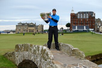 ST ANDREWS, SCOTLAND - OCTOBER 05:  Oliver Wilson of England holds the trophy aloft on the Swilken Bridge on the 18th hole after victory in the 2014 Alfred Dunhill Links Championship at The Old Course on October 5, 2014 in St Andrews, Scotland.  (Photo by