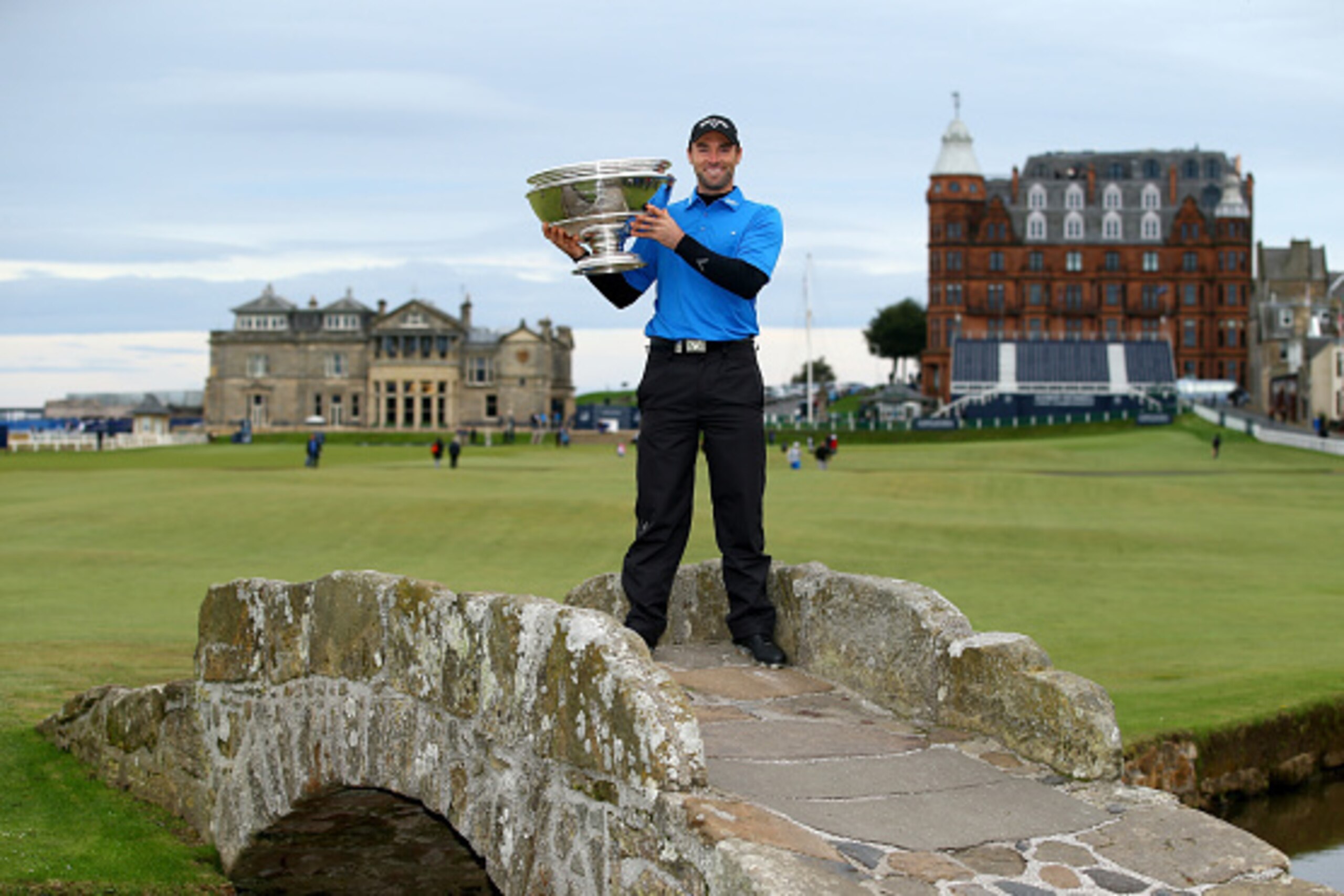 ST ANDREWS, SCOTLAND - OCTOBER 05:  Oliver Wilson of England holds the trophy aloft on the Swilken Bridge on the 18th hole after victory in the 2014 Alfred Dunhill Links Championship at The Old Course on October 5, 2014 in St Andrews, Scotland.  (Photo by