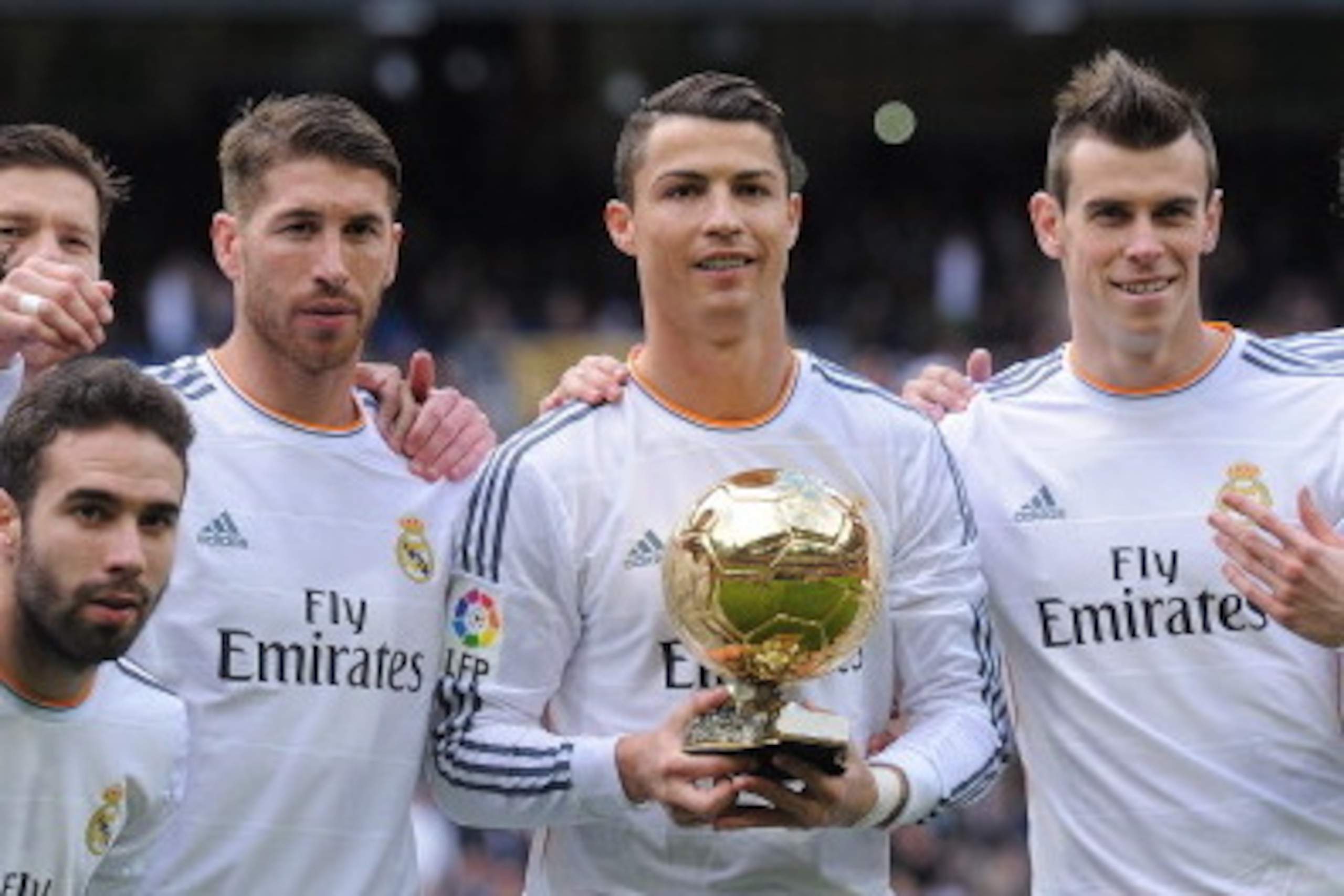 MADRID, SPAIN - JANUARY 25:  Cristiano Ronaldo (3R) of Real Madrid CF holds the Ballon d'Or 2013 award with team mates prior to he start of the La Liga match between Real Madrid CF and Granada CF at Santiago Bernabeu stadium on January 25, 2014 in Madrid,