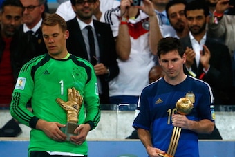 RIO DE JANEIRO, BRAZIL - JULY 13: Manuel Neuer of Germany holds the Golden Glove trophy as Lionel Messi of Argentina holds the Golden Ball trophy during the 2014 FIFA World Cup Brazil Final match between Germany and Argentina at Maracana on July 13, 2014 