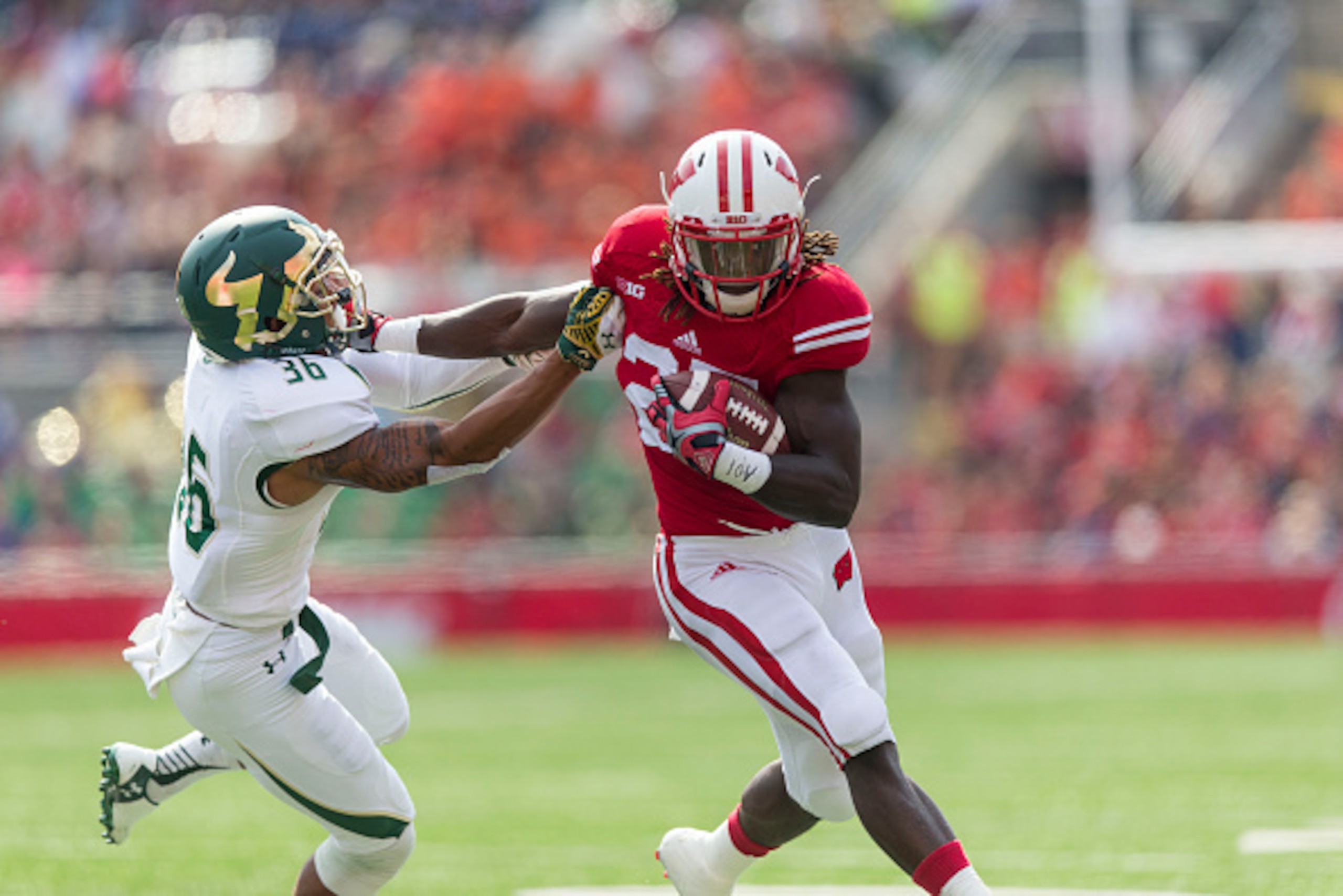 MADISON, WI - SEPTEMBER 27:  Melvin Gordon #25 of the Wisconsin Badgers runs the ball past Nate Goodwin #36 of the South Florida Bulls  on September 27, 2014 at Camp Randall Stadium in Madison, Wisconsin.  (Photo by Tom Lynn/Getty Images)