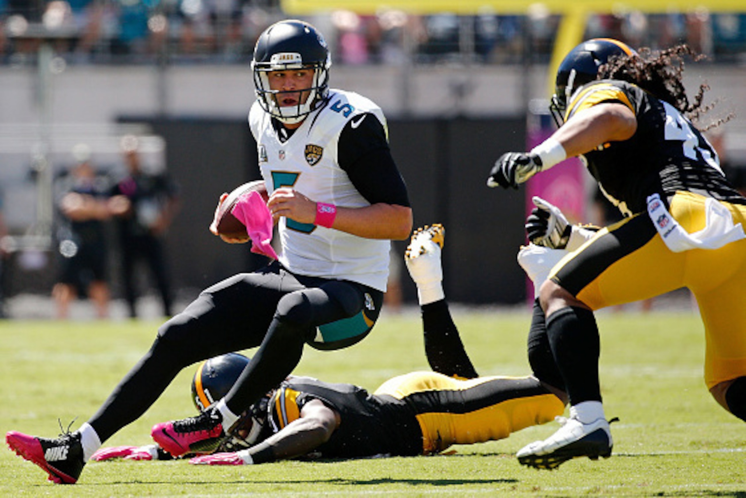 JACKSONVILLE, FL - OCTOBER 05: Blake Bortles #5 of the Jacksonville Jaguars scrambles as Troy Polamalu #43 of the Pittsburgh Steelers comes in to make a tackle during the first quarter of the game at EverBank Field on October 5, 2014 in Jacksonville, Flor