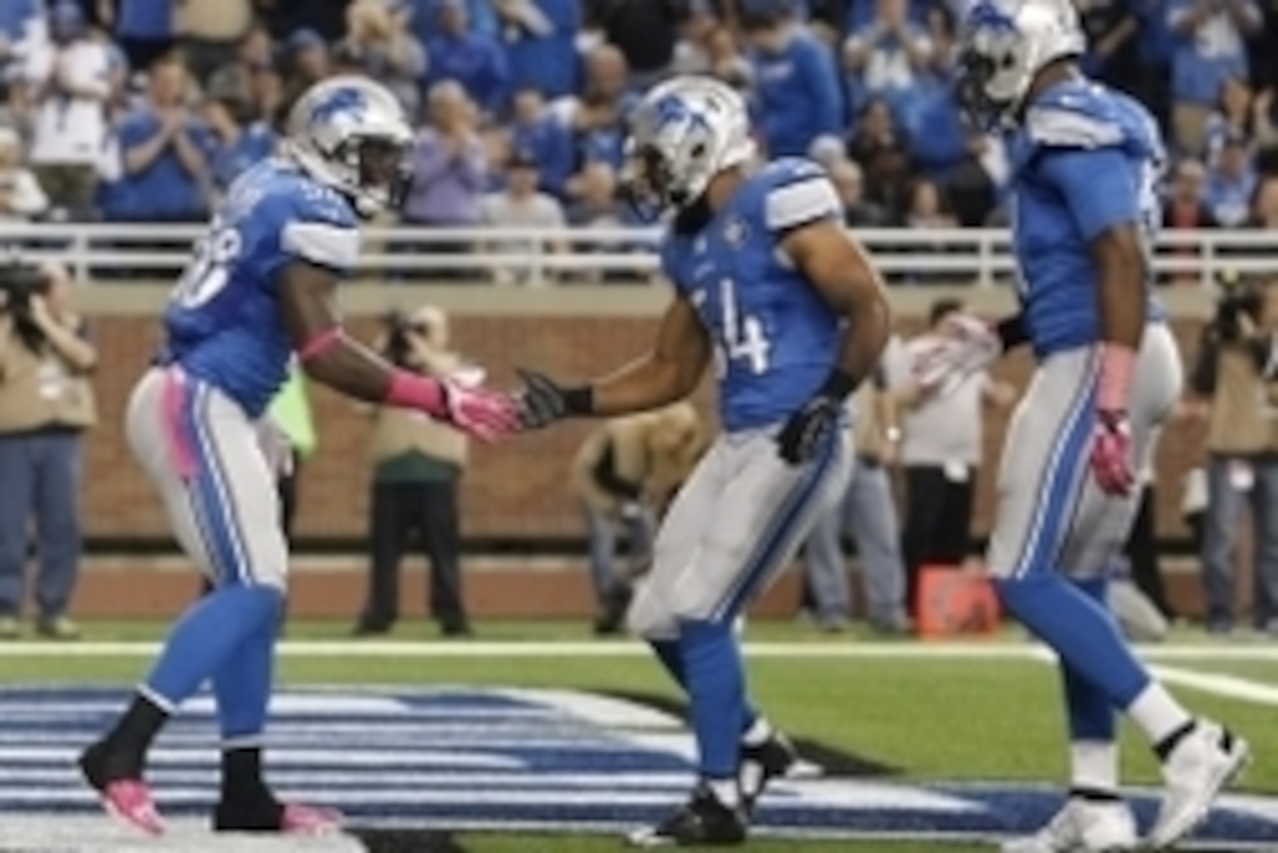Oct 5, 2014; Detroit, MI, USA; Detroit Lions outside linebacker Ashlee Palmer (58) celebrates with outside linebacker DeAndre Levy (54) after a sack during the first quarter against the Buffalo Bills at Ford Field. Mandatory Credit: Raj Mehta-USA TODAY Sp