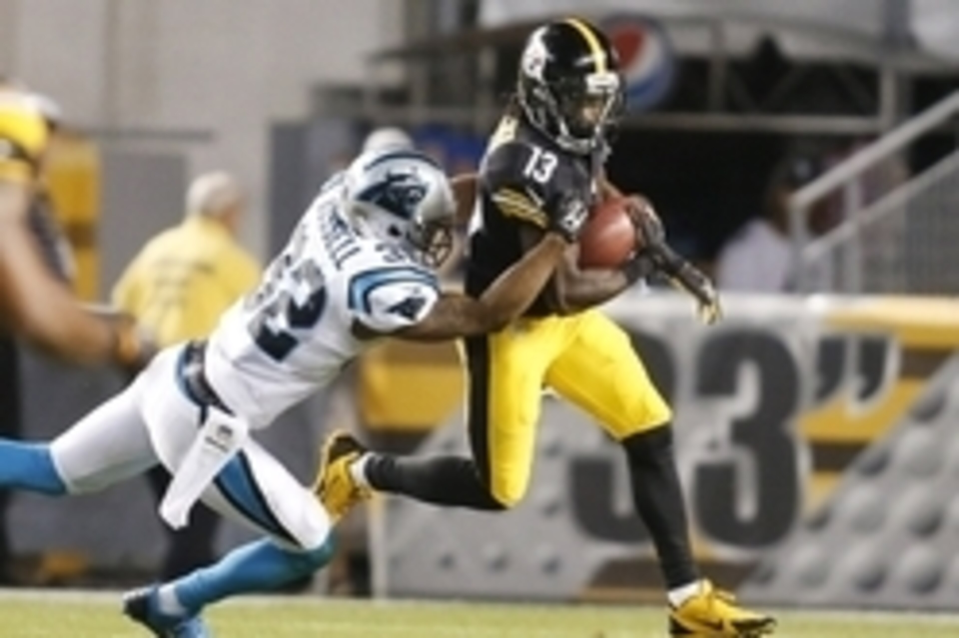 Aug 28, 2014; Pittsburgh, PA, USA; Pittsburgh Steelers running back Dri Archer (13) returns a punt as Carolina defensive back Anderson Russell (32) attempts a tackle during the fourth quarter at Heinz Field. The Panthers shutout the Steelers 10-0. Mandato Aug 28, 2014; Pittsburgh, PA, USA; Pittsburgh Steelers running back Dri Archer (13) returns a punt as Carolina defensive back Anderson Russell (32) attempts a tackle during the fourth quarter at Heinz Field. The Panthers shutout the Steelers 10-0. Mandato