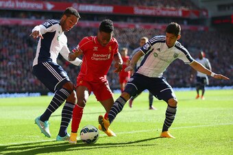 LIVERPOOL, ENGLAND - OCTOBER 04: : Raheem Sterling of Liverpool is closed down by Joleon Lescott and Cristian Gamboa of West Brom during the Barclays Premier League match between Liverpool and West Bromwich Albion at Anfield on October 4, 2014 in Liverpoo