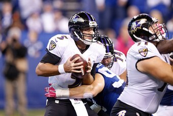 INDIANAPOLIS, IN - OCTOBER 5: Joe Flacco #5 of the Baltimore Ravens gets sacked by Bjoern Werner #92 of the Indianapolis Colts in the fourth quarter of the game at Lucas Oil Stadium on October 5, 2014 in Indianapolis, Indiana. The Colts defeated the Raven