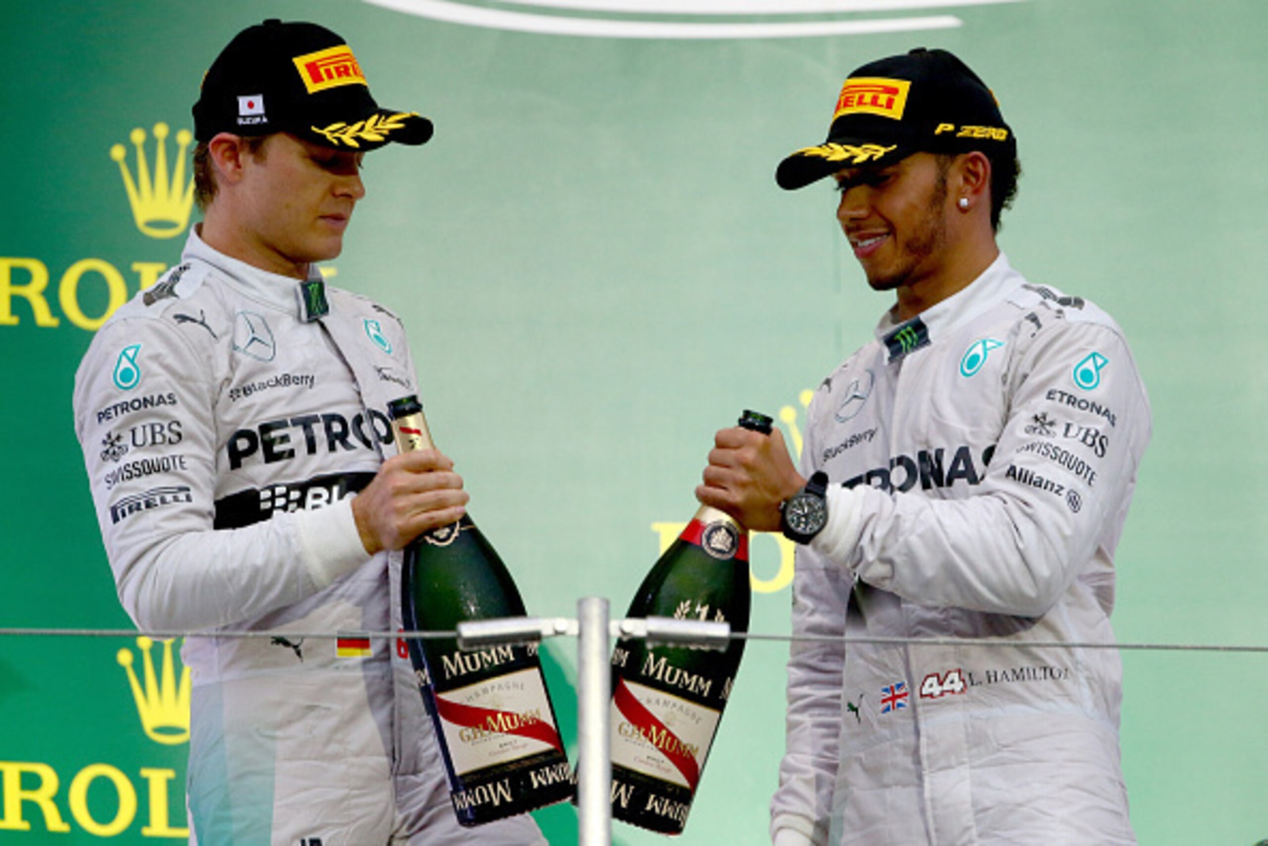 SUZUKA, JAPAN - OCTOBER 05:  Lewis Hamilton and Nico Rosberg of Mercedes GP celebrate on the podium following the Japanese Formula One Grand Prix at Suzuka Circuit on October 5, 2014 in Suzuka, Japan.  (Photo by Clive Rose/Getty Images)