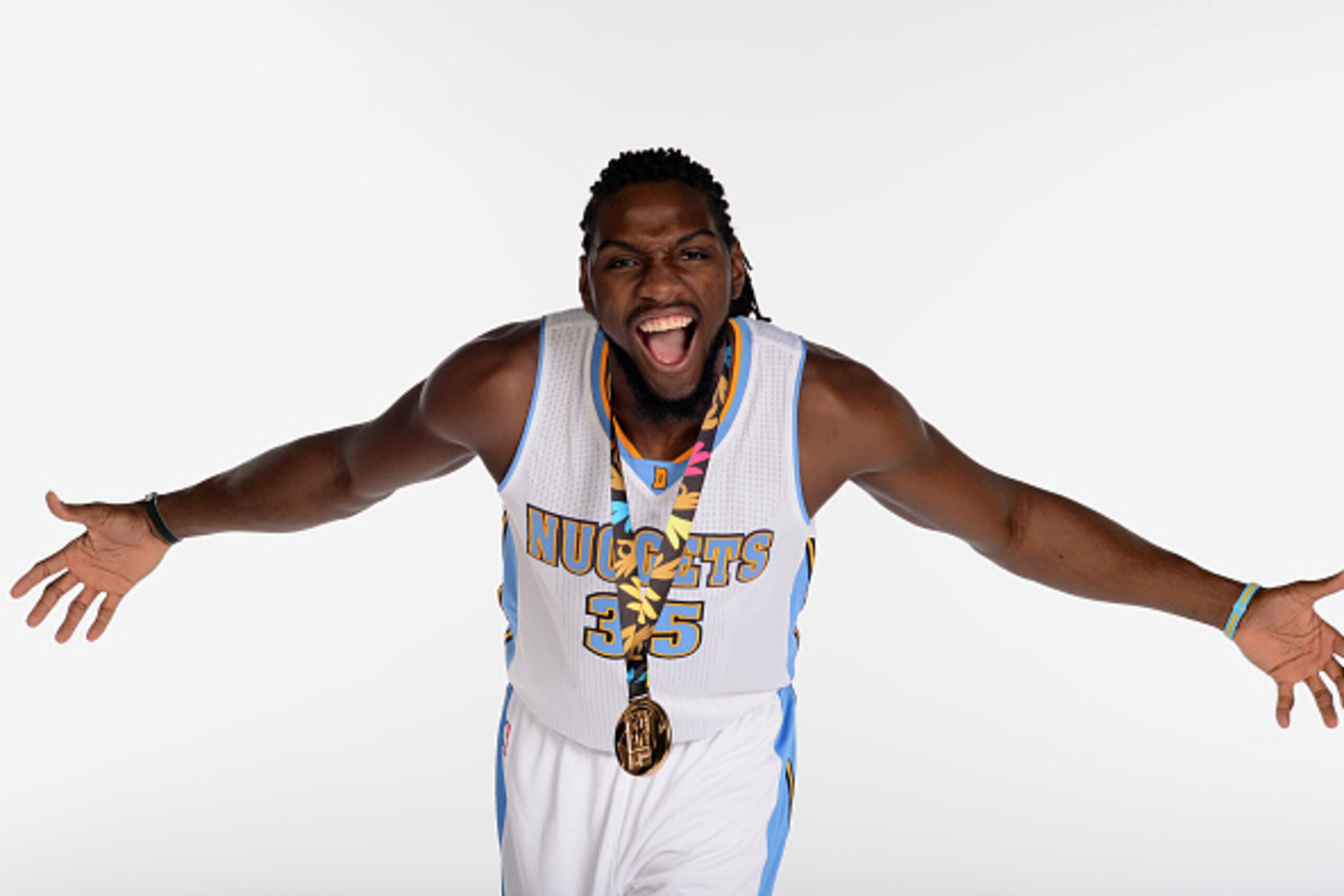 DENVER, CO - SEPTEMBER 29: Kenneth Faried #35 of the Denver Nuggets poses with his gold medal from the 2014 FIBA World Cup of  Basketball during media day on September 29, 2014 at the Pepsi Center in Denver, Colorado. NOTE TO USER: User expressly acknowle