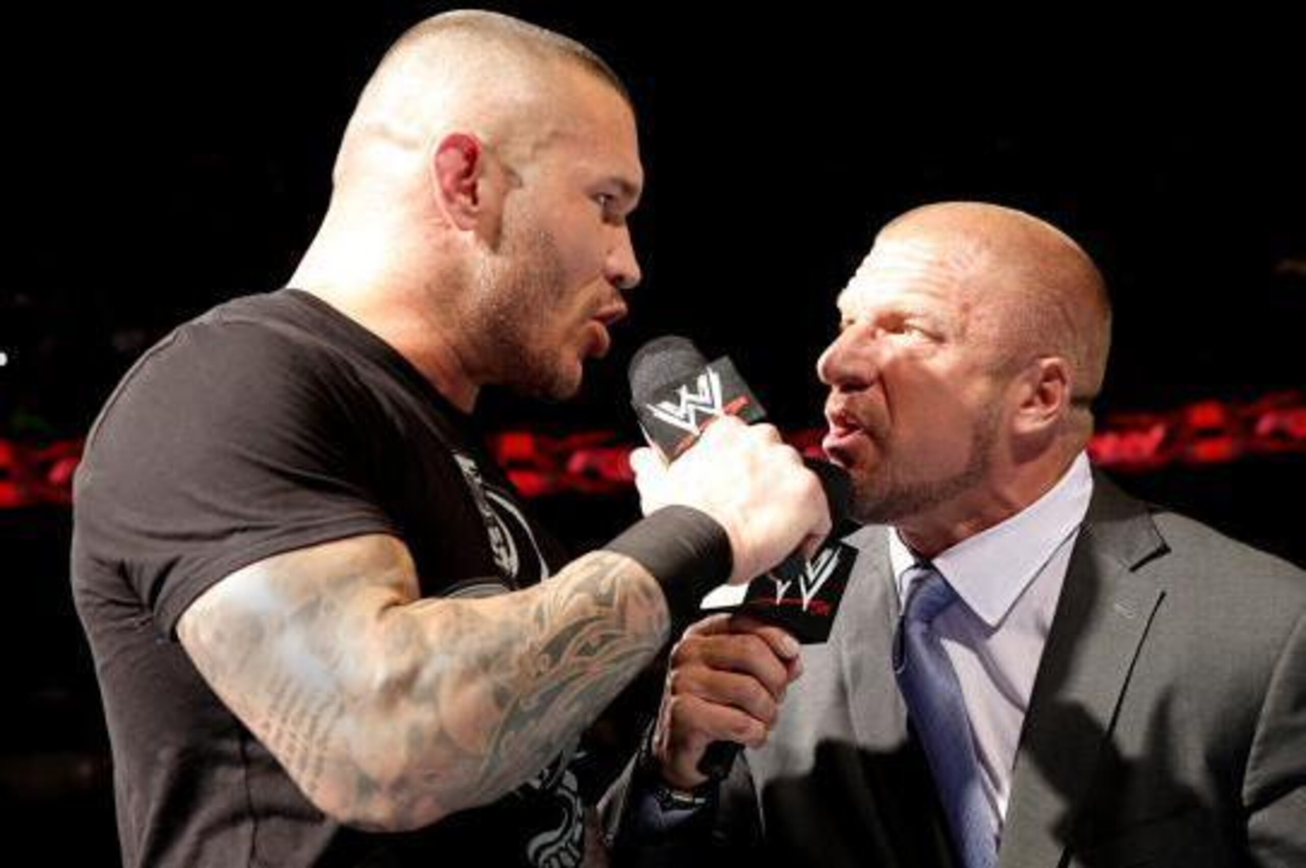 Randy Orton argues with Triple H .