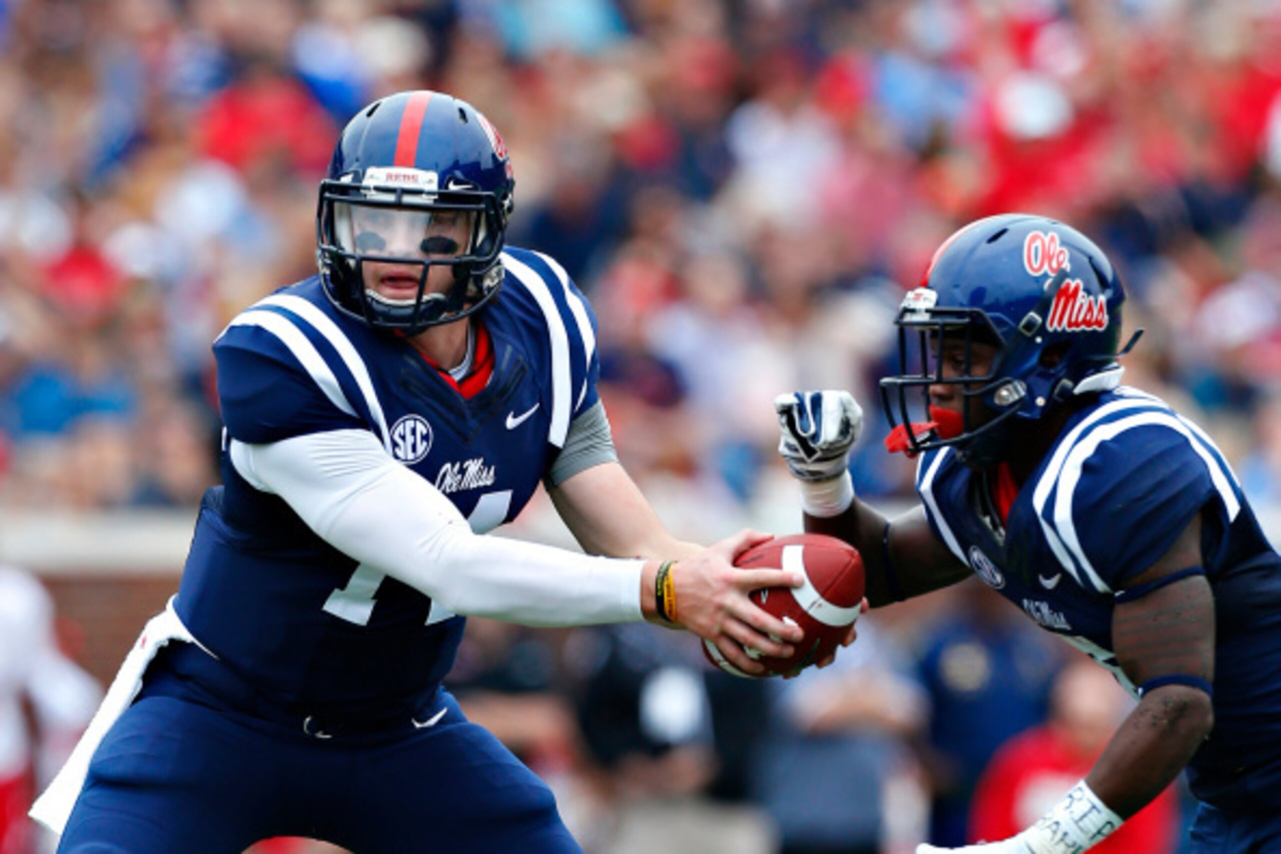OXFORD, MS - SEPTEMBER 13:  Bo Wallace #14 of the Ole Miss Rebels fakes a handoff in the backfield during a game against the Louisiana-Lafayette Ragin' Cajuns at Vaught-Hemingway Stadium on September 13, 2014 in Oxford, Mississippi.  (Photo by Wesley Hitt