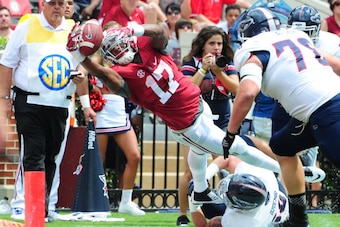 TUSCALOOSA, AL - SEPTEMBER 6: Kenyan Drake #17 of the Alabama Crimson Tide dives just short of the goal line against Nate Ozdemir #50 of the Florida Atlantc Owls at Bryant-Denny Stadium on September 6, 2014 in Tuscaloosa, Alabama. (Photo by Scott Cunningh
