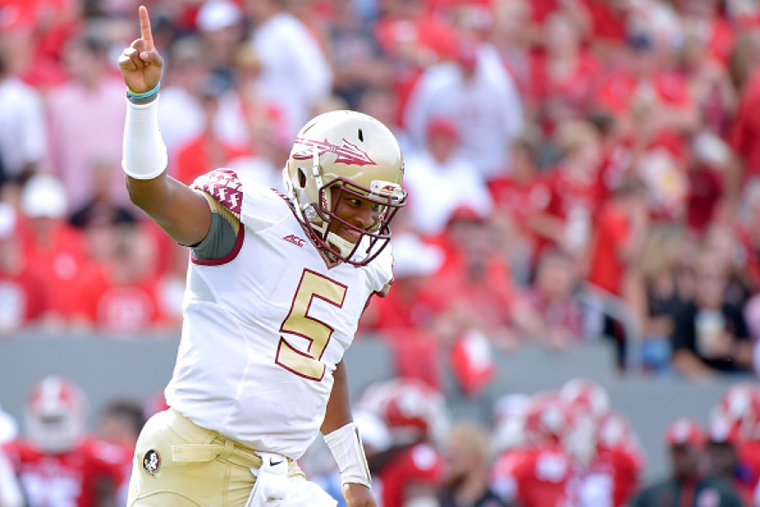 RALEIGH, NC - SEPTEMBER 27:  Jameis Winston #5 of the Florida State Seminoles celebrates after throwing a first quarter touchdown pass during their game against the North Carolina State Wolfpack at Carter-Finley Stadium on September 27, 2014 in Raleigh, N