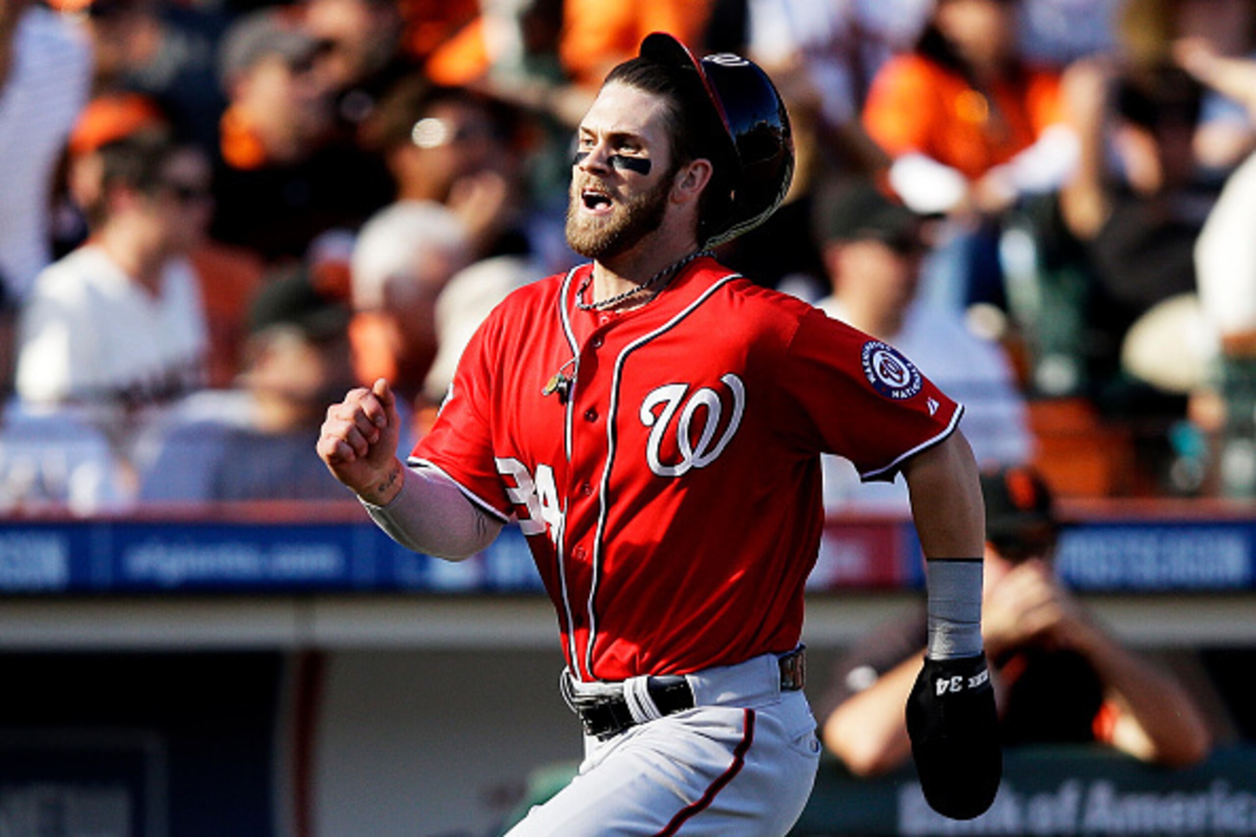 SAN FRANCISCO, CA - OCTOBER 06:  Bryce Harper #34 of the Washington Nationals runs to score on a throwing error by Madison Bumgarner #40 of the San Francisco Giants in the seventh inning during Game Three of the National League Division Series at AT&T Par