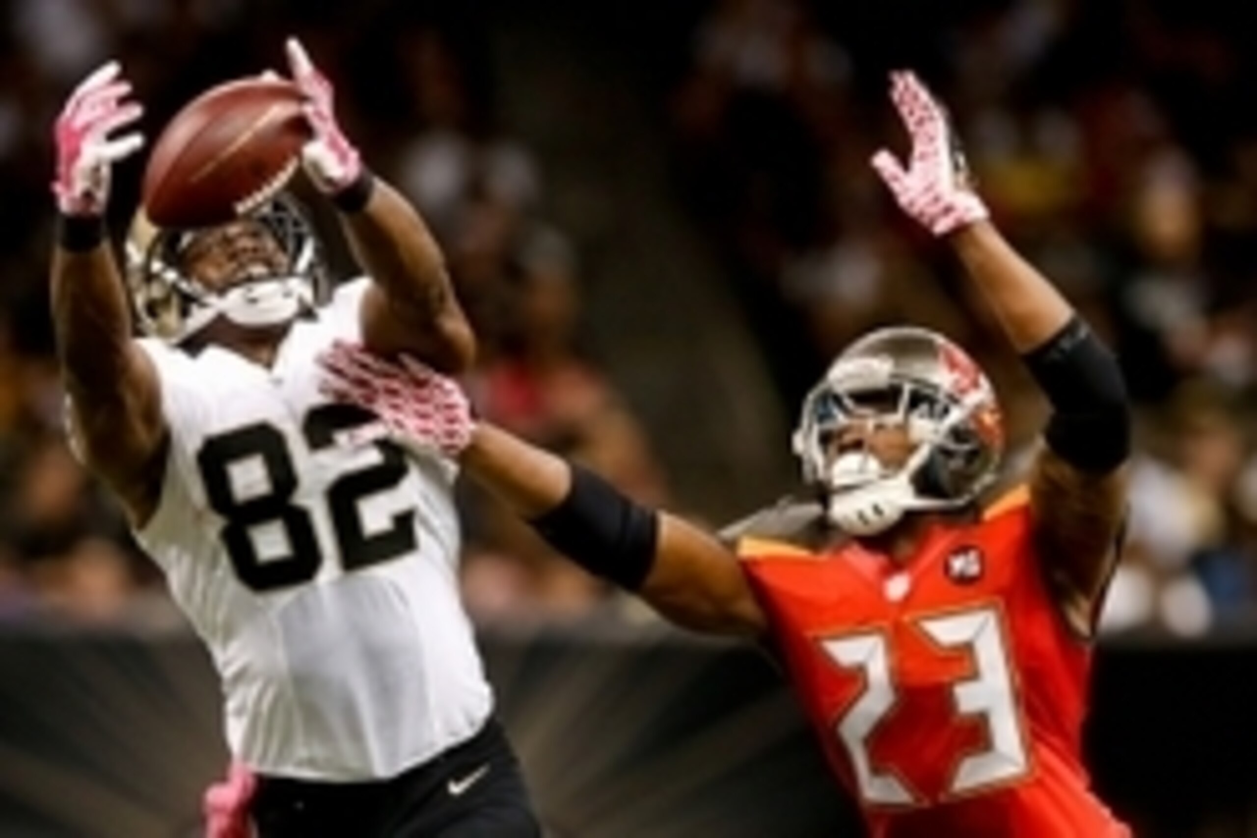 Oct 5, 2014; New Orleans, LA, USA; Tampa Bay Buccaneers strong safety Mark Barron (23) breaks up a pass to New Orleans Saints tight end Benjamin Watson (82) during overtime of a game at Mercedes-Benz Superdome. The Saints defeated the Buccaneers 37-31 in 