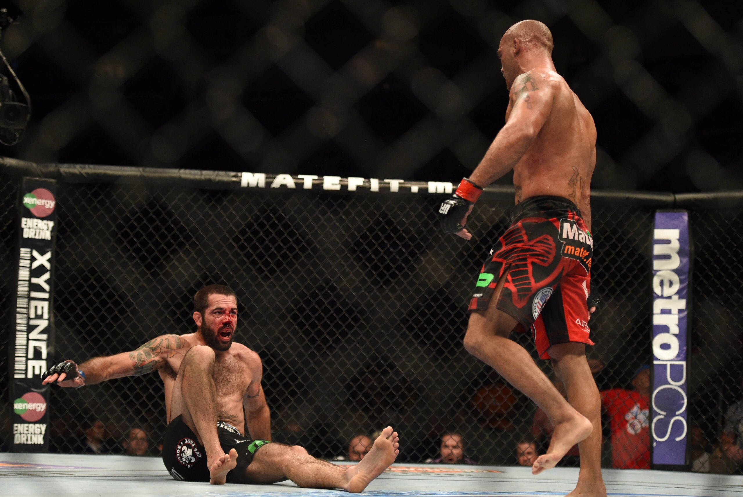 July 26, 2014; San Jose, CA, USA; Robbie Lawler (red gloves) knocks down Matt Brown (blue gloves) during the welterweight bout of the FOX UFC Saturday at SAP Center. Mandatory Credit: Kyle Terada-USA TODAY Sports