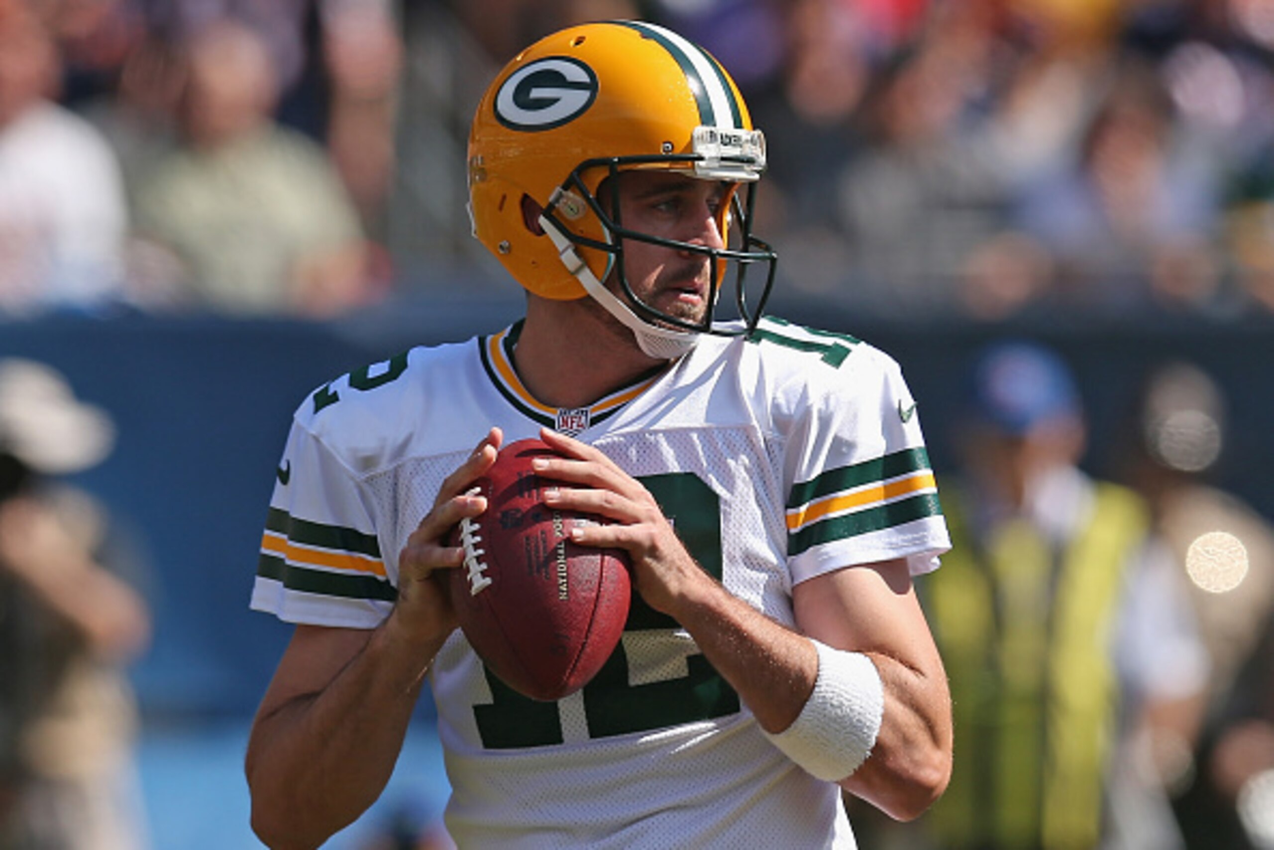 CHICAGO, IL - SEPTEMBER 28:  Aaron Rodgers #12 of the Green Bay Packers looks for a receiver against the Chicago Bears at Soldier Field on September 28, 2014 in Chicago, Illinois. The Packers defeated the Bears 38-17.  (Photo by Jonathan Daniel/Getty Imag