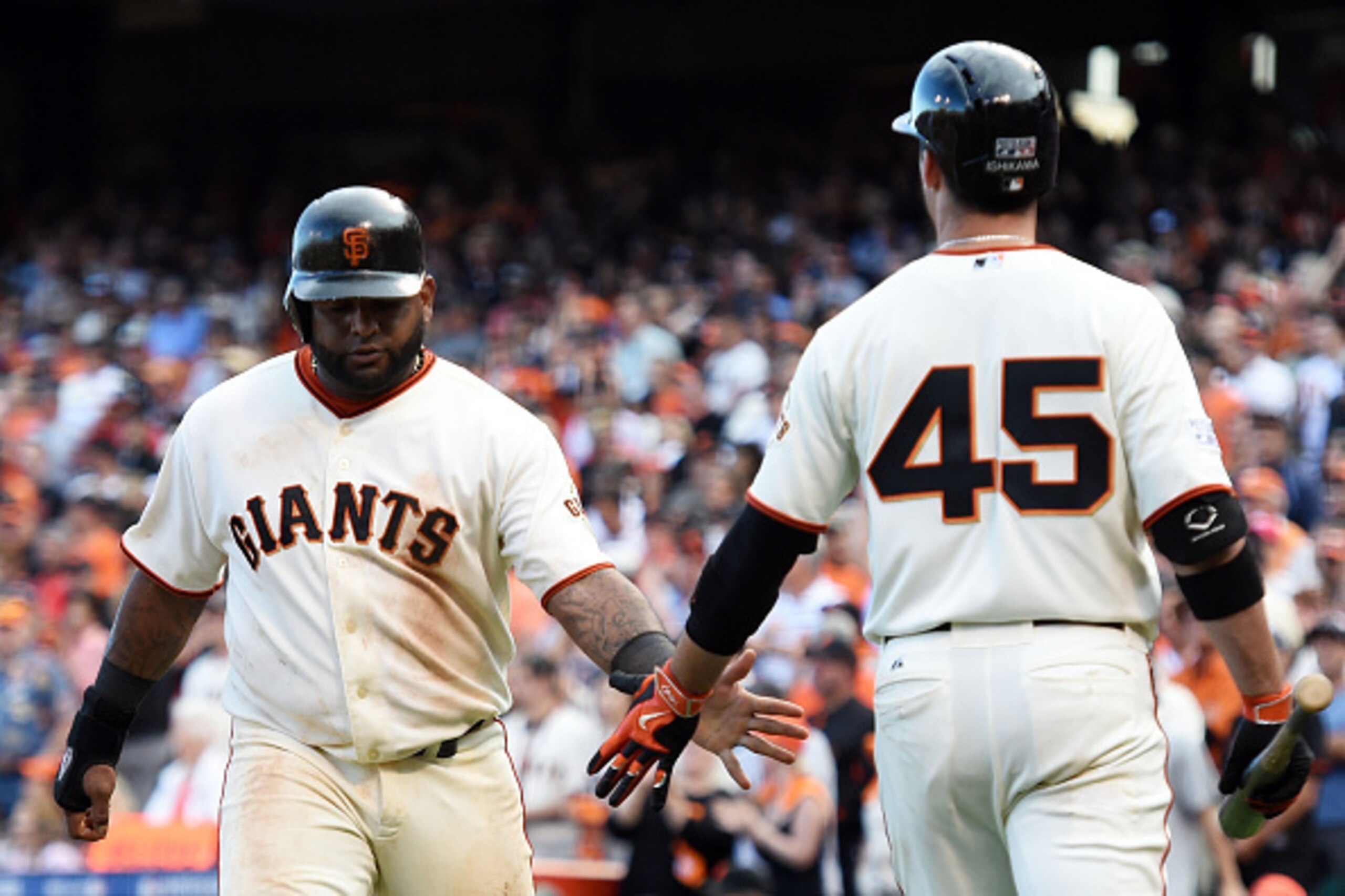 SAN FRANCISCO, CA - OCTOBER 06:  Pablo Sandoval #48 celebrates with Travis Ishikawa #45 of the San Francisco Giants after scoring in the ninth inning against the Washington Nationals during Game Three of the National League Division Series at AT&T Park on