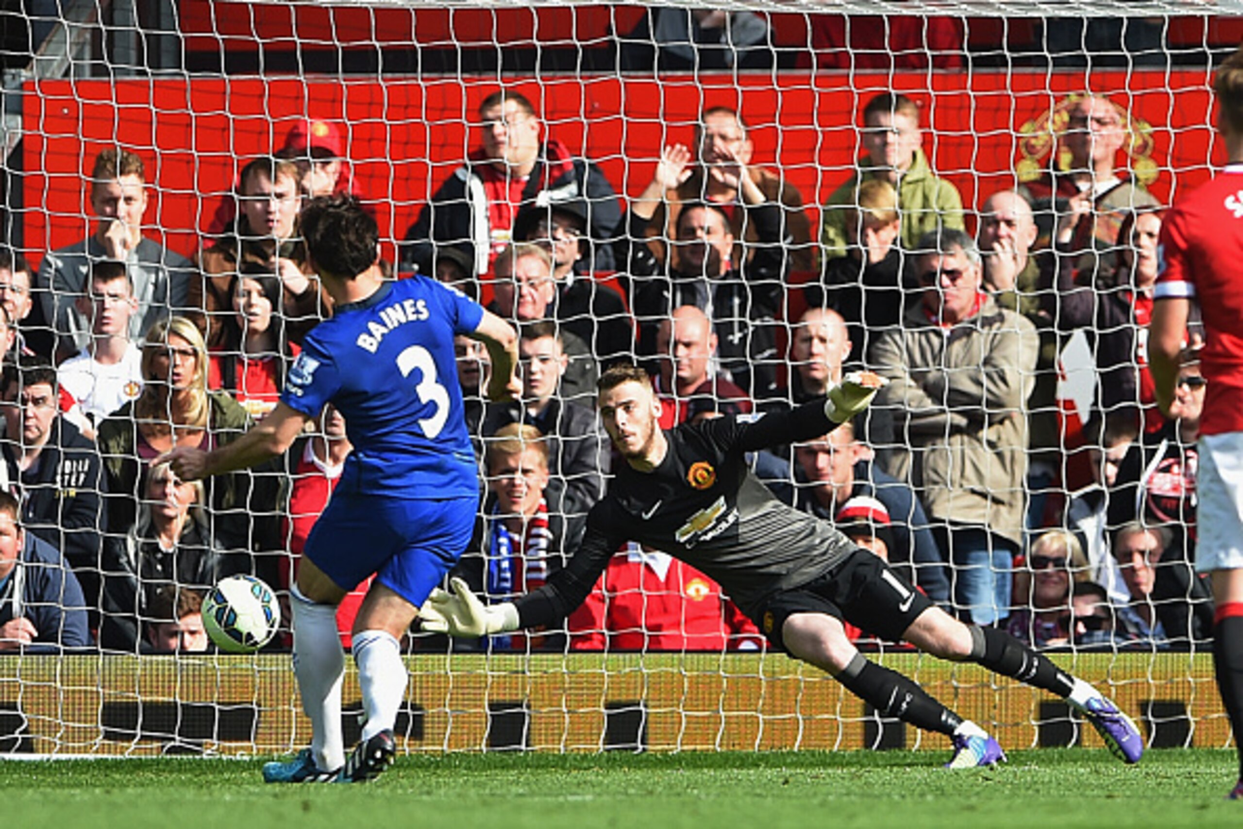 MANCHESTER, ENGLAND - OCTOBER 05:  Leighton Baines of Everton takes and has a penalty kick saved by David De Gea of Manchester United during the Barclays Premier League match between Manchester United and Everton at Old Trafford on October 5, 2014 in Manc