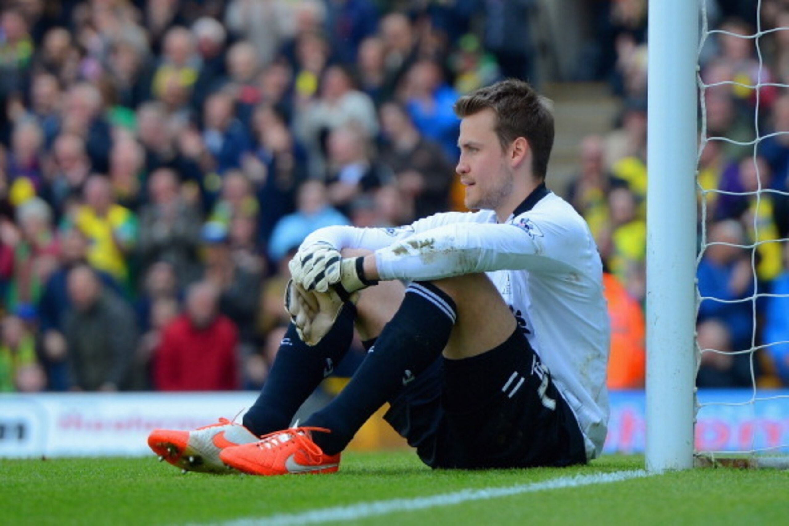 NORWICH, ENGLAND - APRIL 20: A dejected Simon Mignolet of Liverpool sits on the pitch after conceding a second goal during the Barclays Premier League match between Norwich City and Liverpool at Carrow Road on April 20, 2014 in Norwich, England. (Photo b NORWICH, ENGLAND - APRIL 20: A dejected Simon Mignolet of Liverpool sits on the pitch after conceding a second goal during the Barclays Premier League match between Norwich City and Liverpool at Carrow Road on April 20, 2014 in Norwich, England. (Photo b