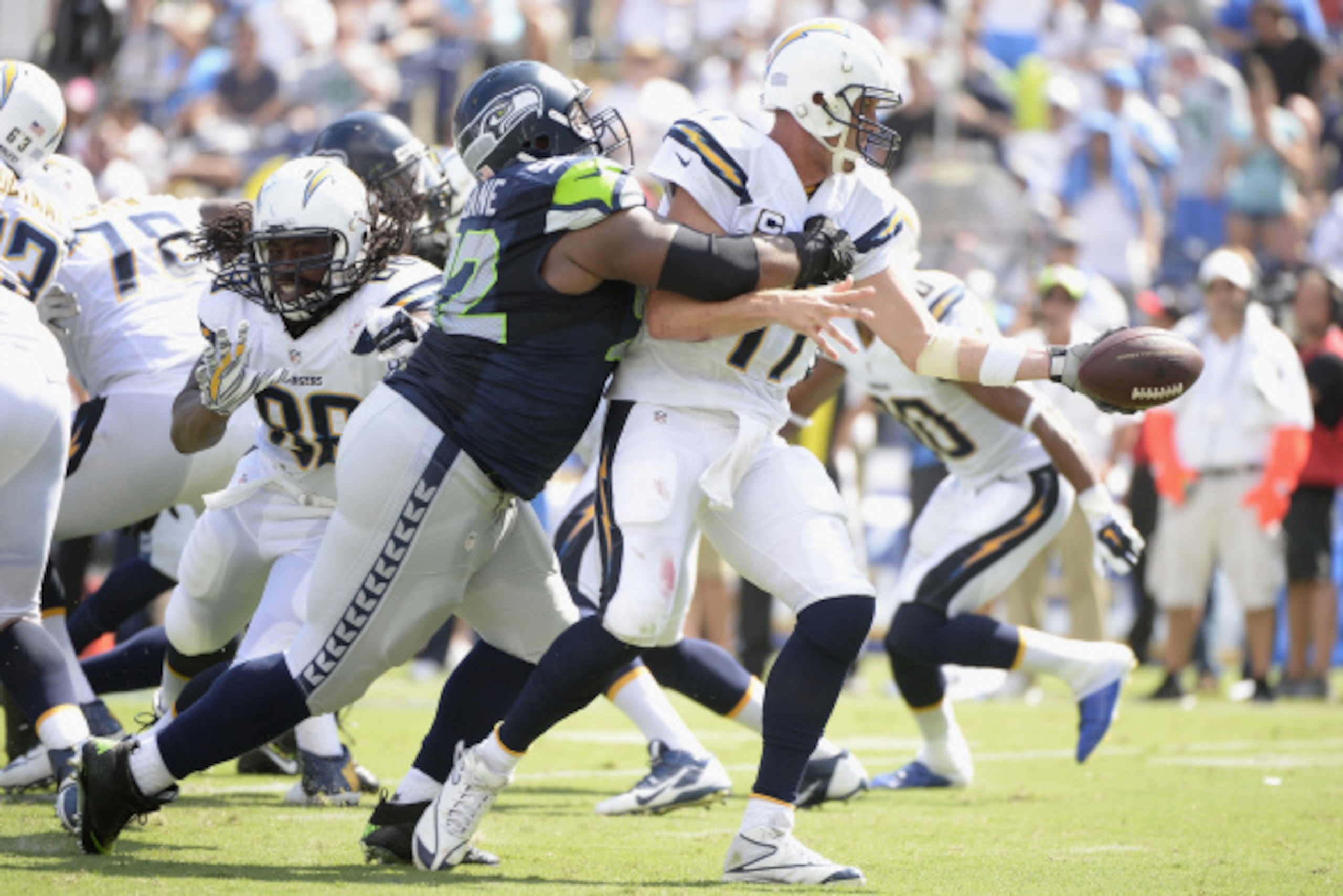 SAN DIEGO, CA - SEPTEMBER 14:  Quarterback Philip Rivers #17 of the San Diego Chargers looks to pass while defended by defensive tackle Brandon Mebane #92 of the Seattle Seahawks at Qualcomm Stadium on September 14, 2014 in San Diego, California.  (Photo 