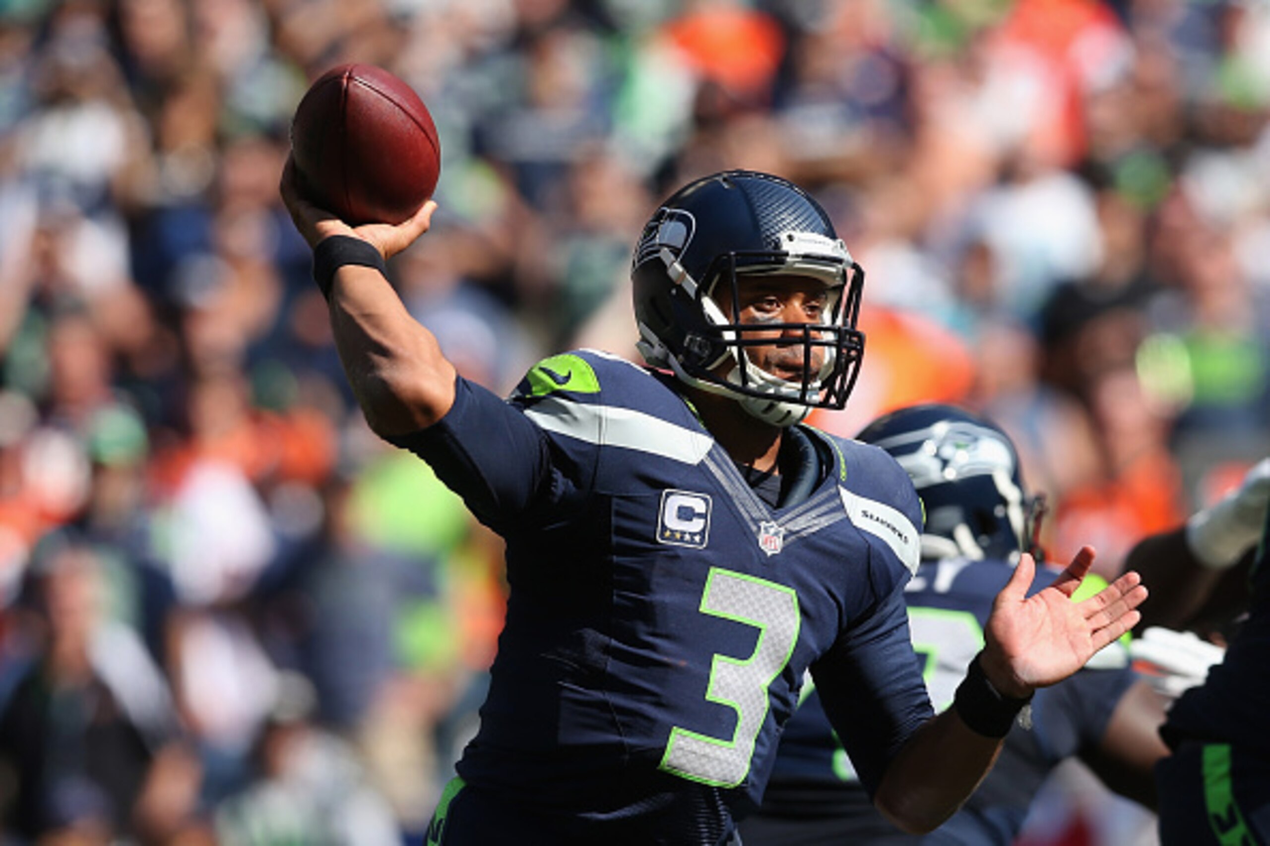 SEATTLE, WA - SEPTEMBER 21:  Quarterback Russell Wilson #3 of the Seattle Seahawks drops back to pass against the Denver Broncos at CenturyLink Field on September 21, 2014 in Seattle, Washington.  (Photo by Jeff Gross/Getty Images)