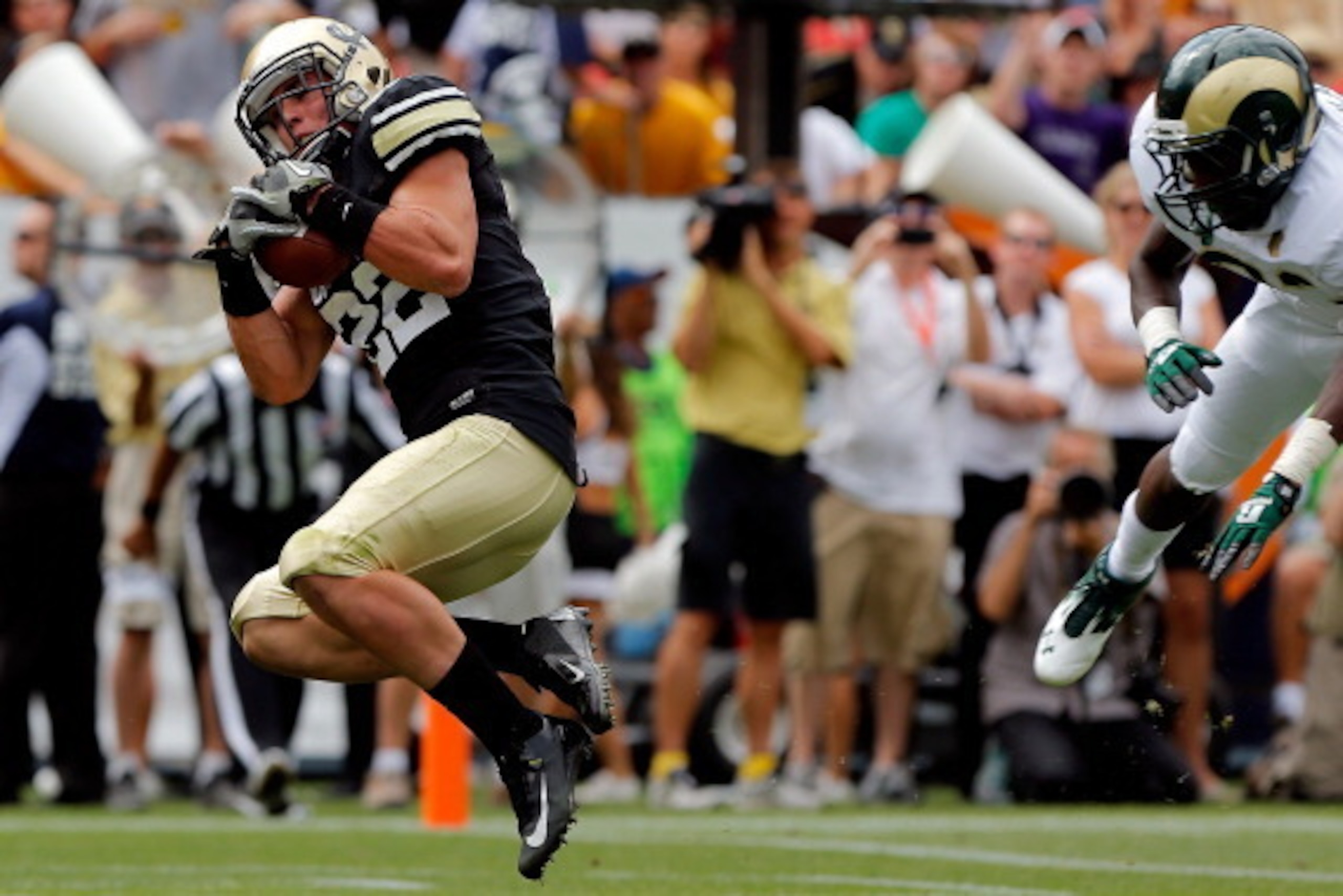 DENVER, CO - SEPTEMBER 01: Wide receiver Nelson Spruce #22 of the Colorado Buffaloes makes a touch down recepetion against the Colorado State Rams in the Rocky Mountain Showdown at Sports Authority Field at Mile High on September 1, 2012 in Denver, Color DENVER, CO - SEPTEMBER 01: Wide receiver Nelson Spruce #22 of the Colorado Buffaloes makes a touch down recepetion against the Colorado State Rams in the Rocky Mountain Showdown at Sports Authority Field at Mile High on September 1, 2012 in Denver, Color