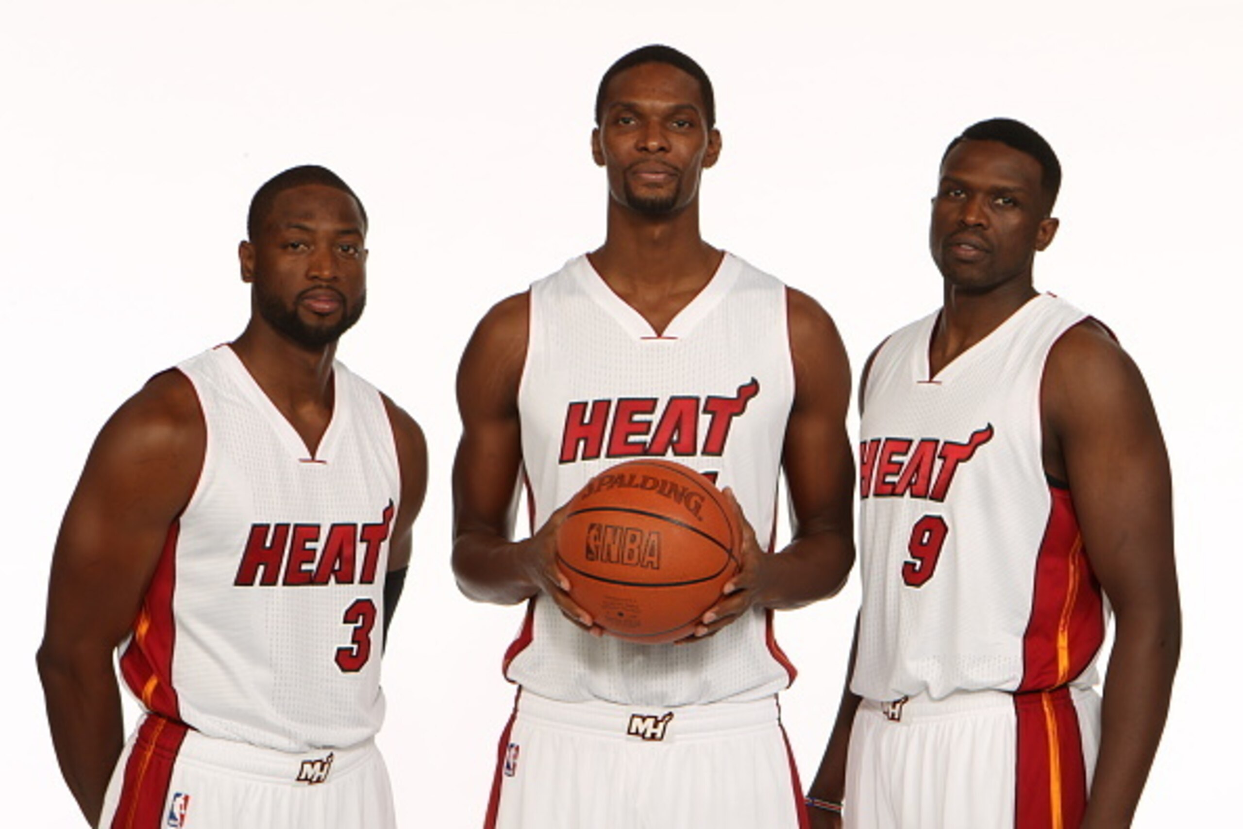MIAMI, FL - SEPTEMBER 26: Dwyane Wade #3, Chris Bosh #1, and Luol Deng #9 of the Miami Heat pose for a portrait during 2014 Media Day at the America Airlines Arena in Miami, Florida. NOTE TO USER: User expressly acknowledges and agrees that, by downloadin